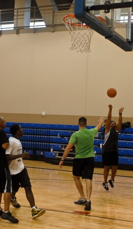 Fallon Robinson shoots a ball for the game point during a three on three basketball game Aug. 4, 2012 at the Warrior Fitness Center, Nellis Air Force Base, Nev. The game was held by the base chapel in support of their outreach program on the chapels sports day.  For more information on the chapel's outreach program or upcoming events contact the base chapel at (702) 652-2950.(U.S. Air Force photo by Senior Airman Jack Sanders)