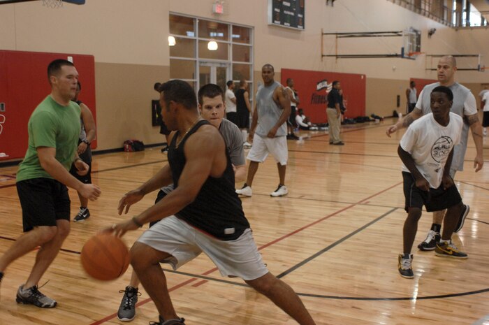 Chapel Outreach program participants play a game of three on three basketball Aug. 4, 2012 at the Warrior Fitness Center on Nellis Air Force Base, Nev. The game was part of the base chapel's sports day in an effort to encourage Airmen to network. For more information on the chapel's outreach program or upcoming events contact the base chapel at (702) 652-2950. (U.S. Air Force photo by Senior Airman Jack Sanders)