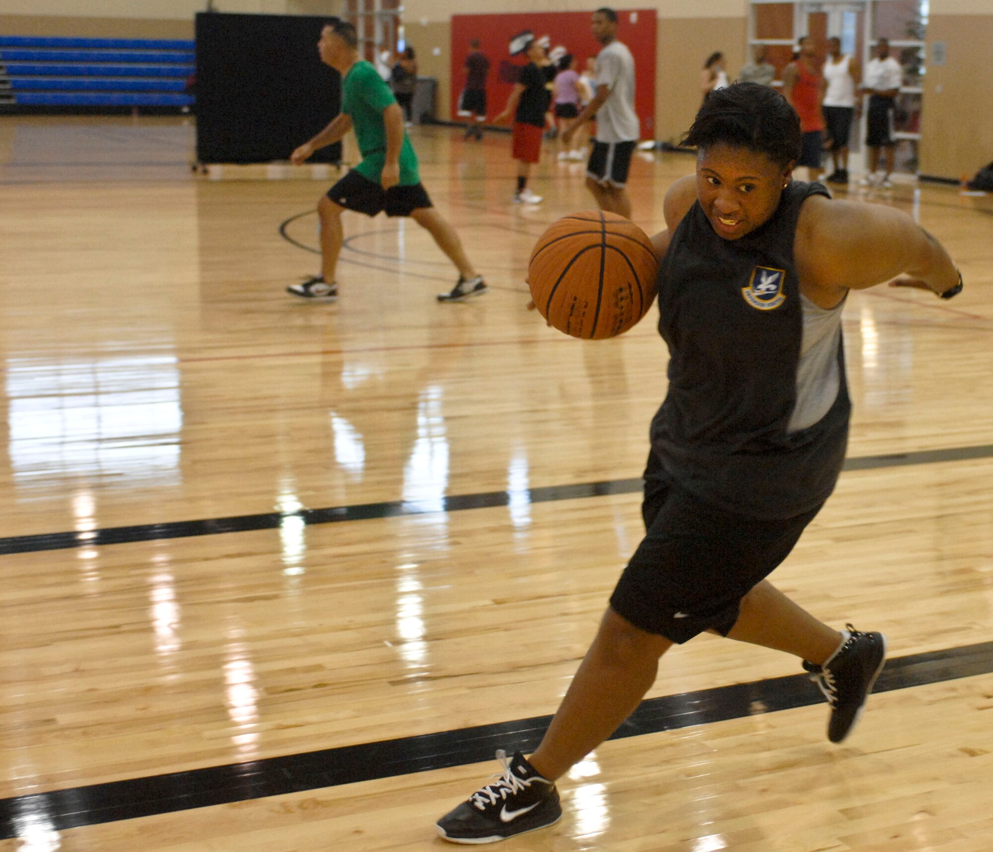 Fallon Robinson drives a ball down the court during a three on three basketball game Aug. 4, 2012 at the Warrior Fitness Center, Nellis Air Force Base, Nev. The game was held by the base chapel in support of their outreach program. For more information on the chapel's outreach program or upcoming events contact the base chapel at (702) 652-2950.(U.S. Air Force photo by Senior Airman Jack Sanders)

