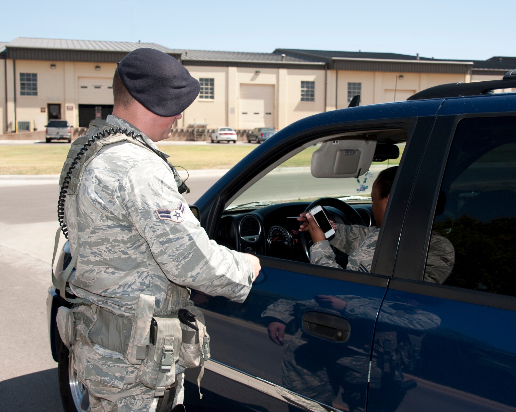 Airman 1st Class Jeffrey Walker conducts a traffic stop on August 2nd, 2012, at Sheppard Air Force Base, Texas.  The 82d Security Forces Squadron is conducting a traffic safety campaign throughout the month of August, focusing on distracted driving.  (U.S. Air Force Photo by Danny Webb) 