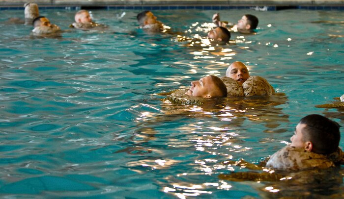 Marines from the 6th Motor Battalion, a Marine Reserve Battalion, stay afloat Aug. 4, 2012, at the Nellis Warrior Fitness Center during their annual aquatic training. During this portion of their training Marines had to quickly remove their trousers and inflate them to be used as a flotation device. (U.S. Air Force photo by Senior Airman Jack Sanders) 