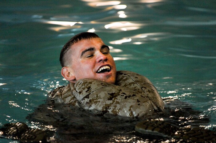 Lance Cpl. Matt Senes, 6th Motor Battalion reserve Marine, sighs in relief after inflating his trousers Aug. 4, 2012 at the Nellis Fitness Center during annual aquatic training. The annual training ensures Marines are able to adapt to finding themselves in an wet situation. (U.S. Air Force photo by Senior Airman Jack Sanders) 