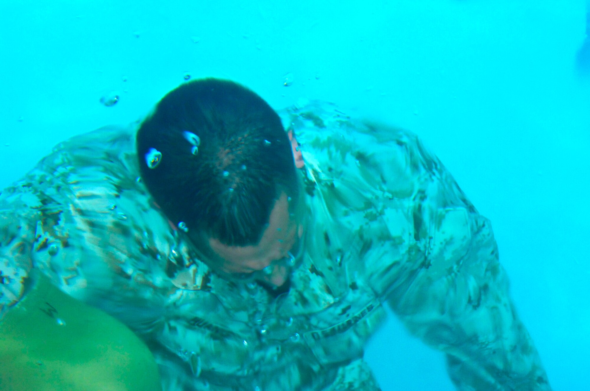 A Marine from the 6th Motor Battalion, a Marine Reserve Battalion, surfaces after retrieving his helmet Aug. 4, 2012 at the Nellis Fitness Center during annual aquatic training. The annual training was held at the Nellis Fitness Center pool because it allows the Marines to fulfill all their training requirements in a safe environment. (U.S. Air Force photo by Senior Airman Jack Sanders) 