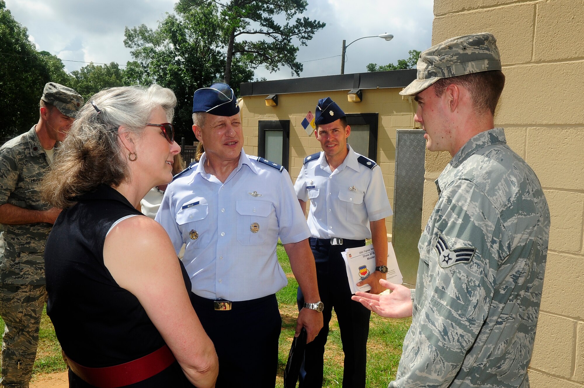 U.S. Air Force Senior Airman William Kries, 20th Civil Engineer Squadron water and fuels system maintenance journeyman, explains how he and his fellow Airmen maintain the water well to Maj. Gen. Lawrence Wells, 9th Air Force commander, and his wife, Kathy Wells, at Shaw Air Force Base, S.C., Aug. 6, 2012. Wells visited different squadrons on base to speak with Airmen and understand their mission and daily duties. (U.S. Air Force photo by Airman 1st Class Hunter Brady/Released)