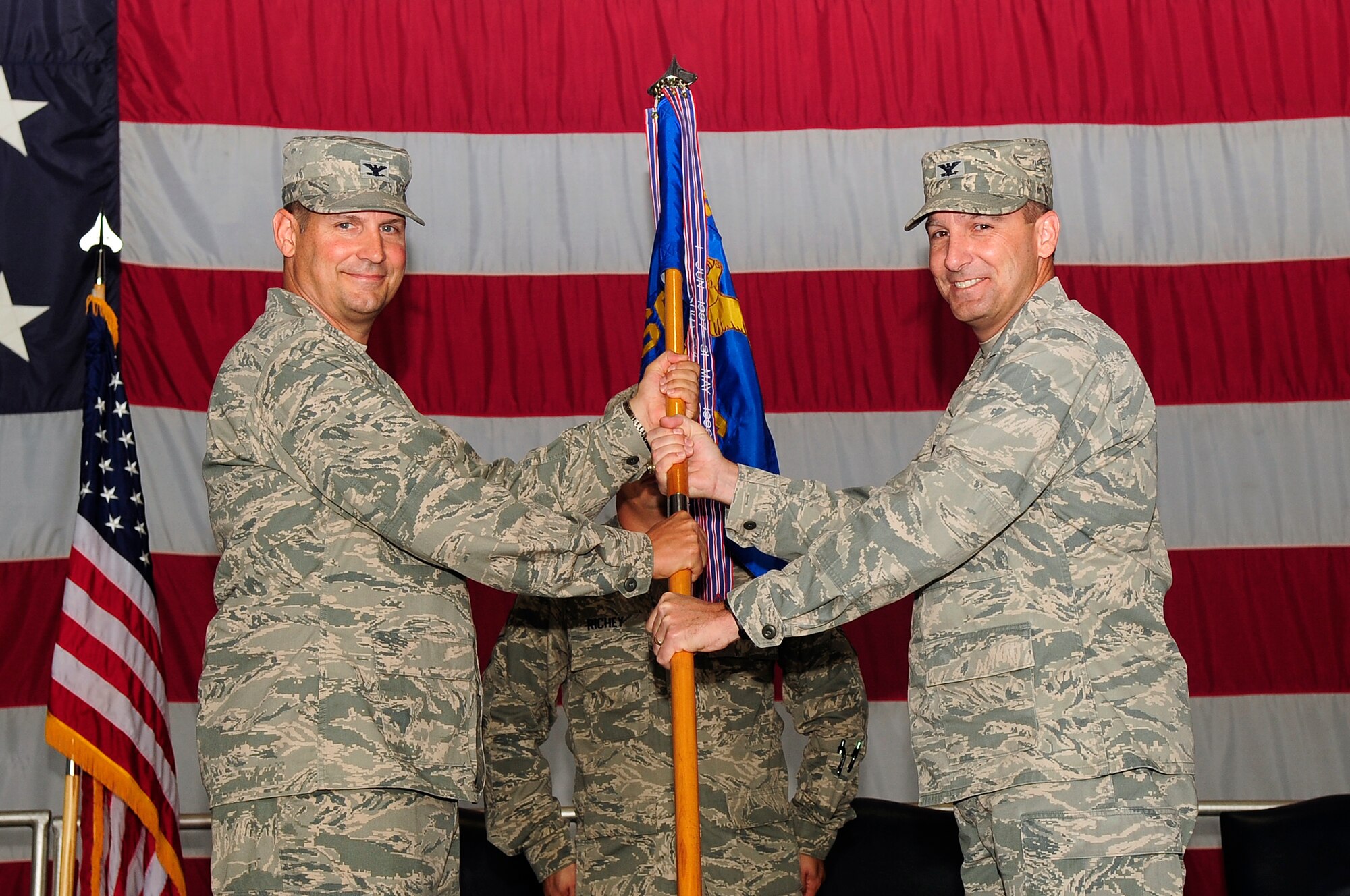 U.S. Air Force Col. Clay Hall, 20th Fighter Wing commander, hands command of the 20th Mission Support Group to Col. Scott Arcuri at Shaw Air Force Base, S.C., Aug. 7, 2012. Arcuri is arriving from U.S. Air Forces Central A1, director of manpower, personnel and services. (U.S. Air Force photo by Airman 1st Class Hunter Brady/Released)