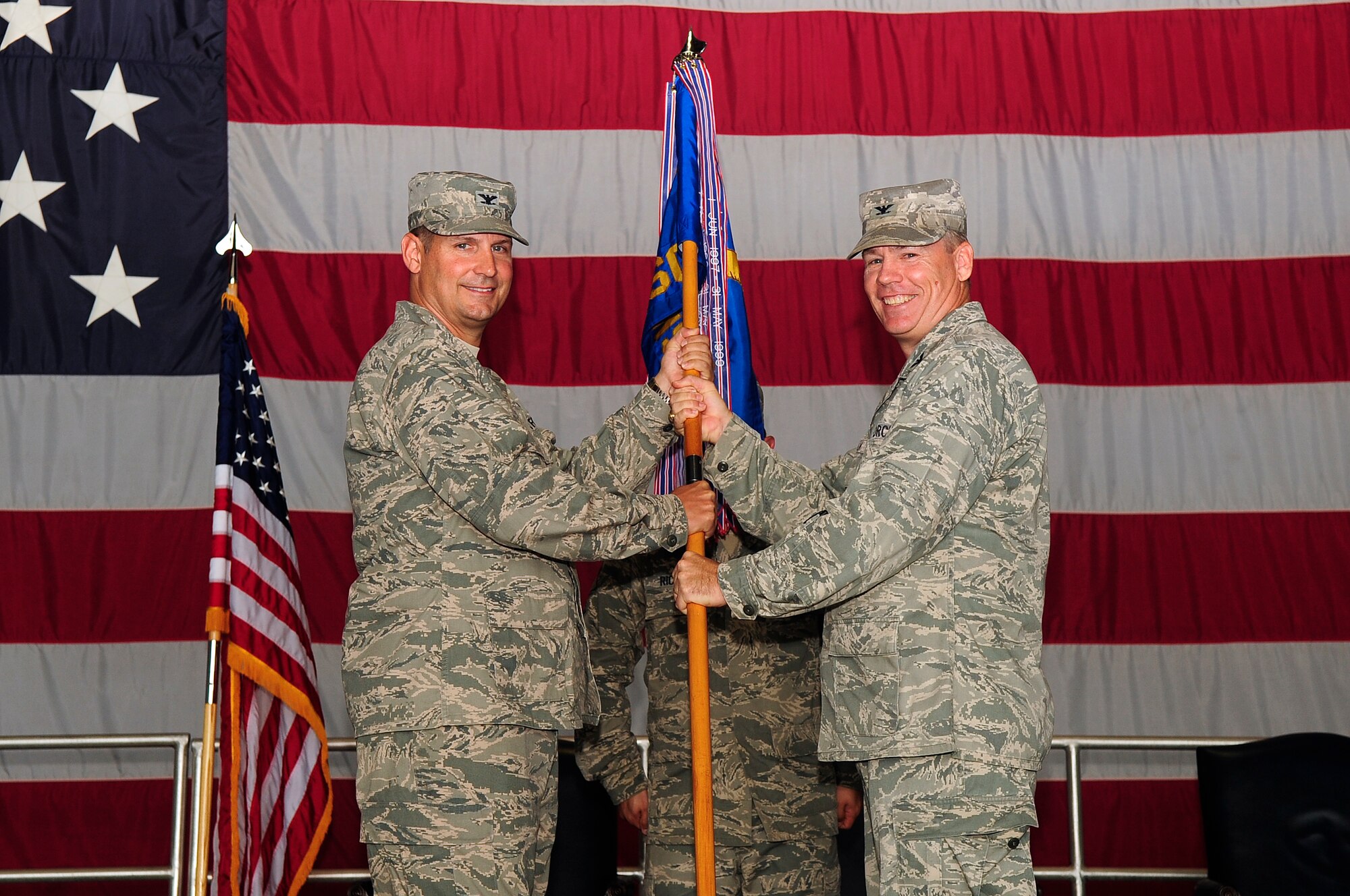 U.S. Air Force Col. Walter Fulda, 20th Mission Support Group commander, passes the squadron flag over to Col. Clay Hall, 20th Fighter Wing commander, at Shaw Air Force Base, S.C., Aug. 7, 2012. Fulda has been the commander of the MSG for 22 months. (U.S. Air Force photo by Airman 1st Class Hunter Brady/Released)