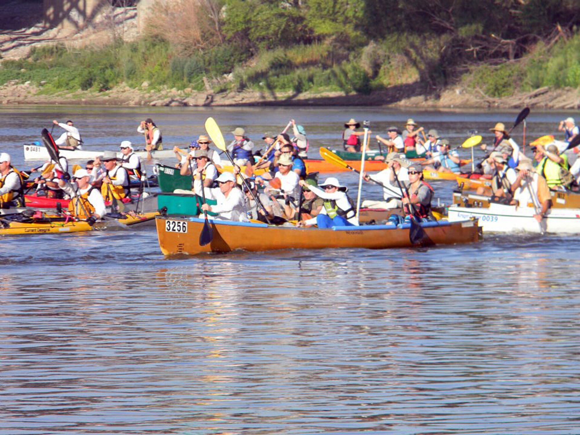 Senior Master Sgt. Jonathan Redfern, Air Mobility Command, his 12 year-old daughter Lauren and her friend Kaitlin Jiral, 21, take off with 340 boats at the 7th Annual MR340 race start line in Kansas City, August 3, 2012, Thier team won third place in their division and 18th overall in the longest canoe race in the world.(Courtesy photo)
