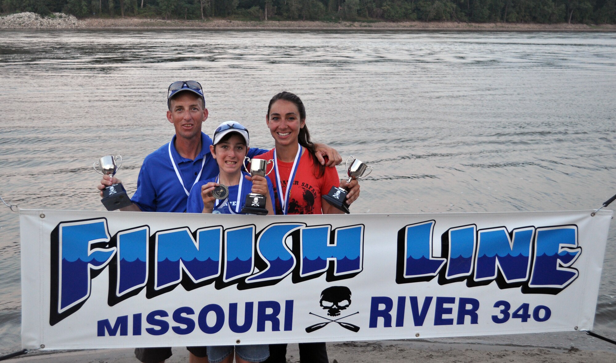 Senior Master Sgt. Jonathan Redfern, Air Mobility Command, his 12 year-old daughter Lauren and her friend Kaitlin Jiral, 21, hold their trophies at the finish line Lewis and Clark Boat House, St. Charles, MO August 3, 2012, after placing their team won third place in their division and 18th overall in the 7th Annual MR340 race. The race is the longest canoe race in the world.(Courtesy photo)

