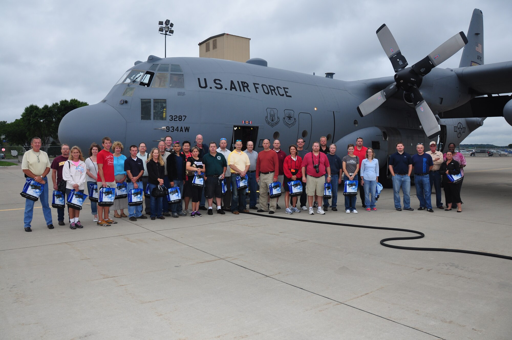 Employers pose next to a 934th Airlift Wing C-130 before their flight for Employers Day Aug. 4. (U.S. Air Force Photo/Paul Zadach)

 