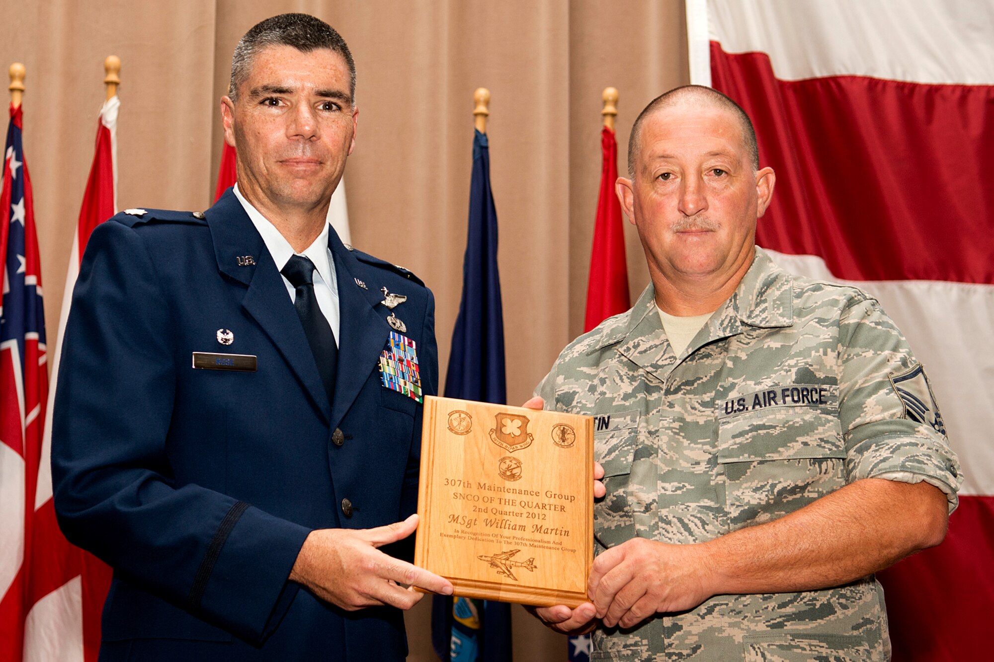 U.S. Air Force Lt. Col. Kenneth Rose, 307th Maintenance Group commander, presents U.S. Air Force Master Sgt. William Martin with a plague during a commander's call ceremony on Aug. 5, 2012, Barksdale Air Force Base, La. Martin was selected as the Senior Noncommissioned Officer of the Quarter for the second quarter of 2012. (U.S. Air Force photo by Master Sgt. Greg Steele/Released)