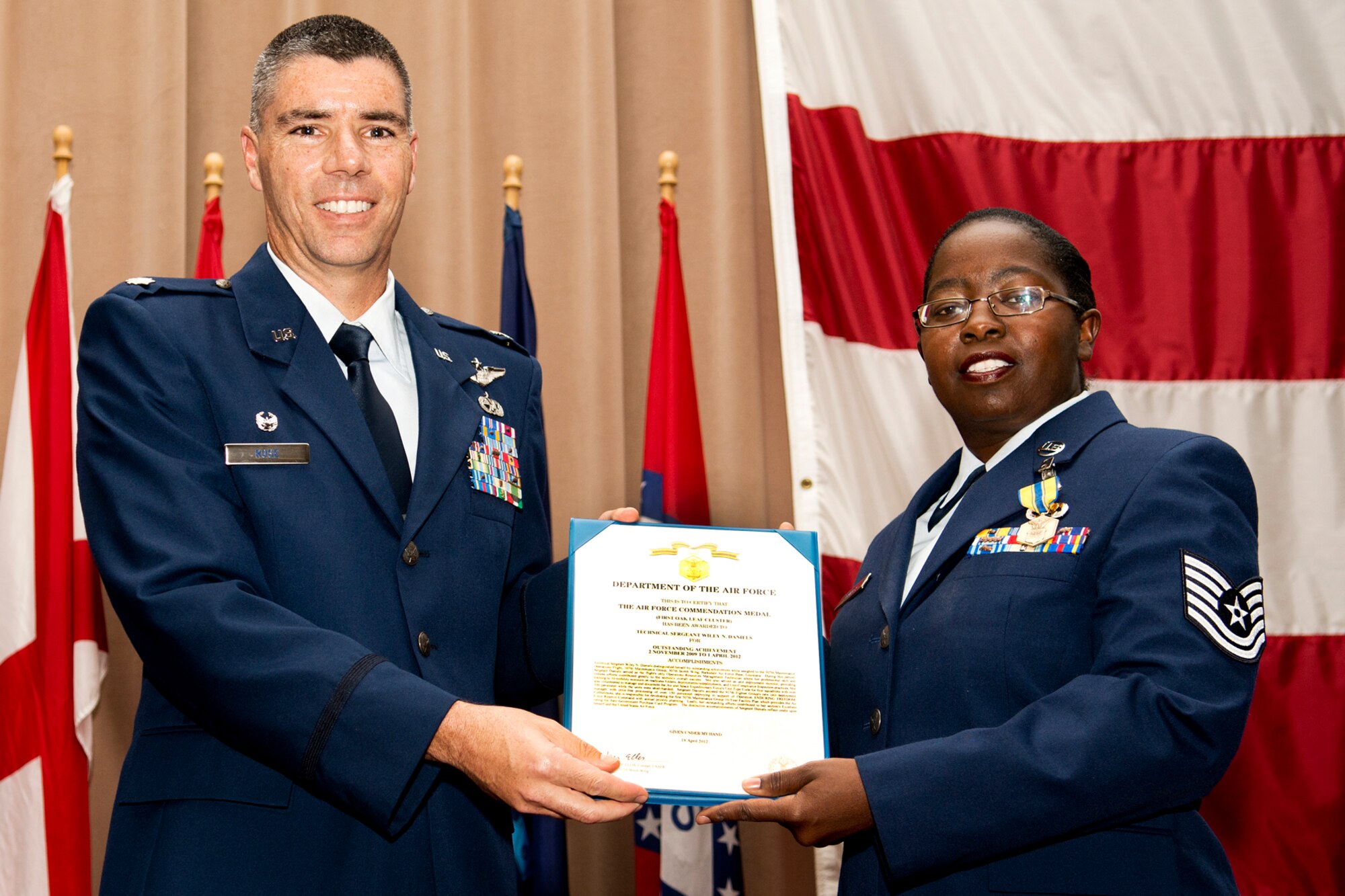 U.S. Air Force Lt. Col. Kenneth Rose, 307th Maintenance Group commander, presents the Air Force Commendation Medal to Tech. Sgt. Wiley Daniels during a commander's call ceremony on Aug. 5, 2012, Barksdale Air Force Base, La. Daniels was recognized for her outstanding achievement from Nov. 2, 2009 to April 1, 2012, in support of the Operation Enduring Freedom and the 307th Bomb Wing. (U.S. Air Force photo by Master Sgt. Greg Steele/Released)