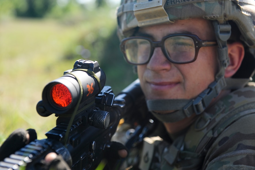 U.S. Army Private 1st Class Ryan Francus, 10th Mountain Division, 4-31 Infantry Battalion, Bravo Company, 2nd Platoon, takes aim during a training scenario at Fort Drum, N.Y., July 25, 2012. Francus established security while his fellow platoon members performed self-aid and buddy care. (U.S. Air Force photo by Airman 1st Class Douglas Ellis/Released)
