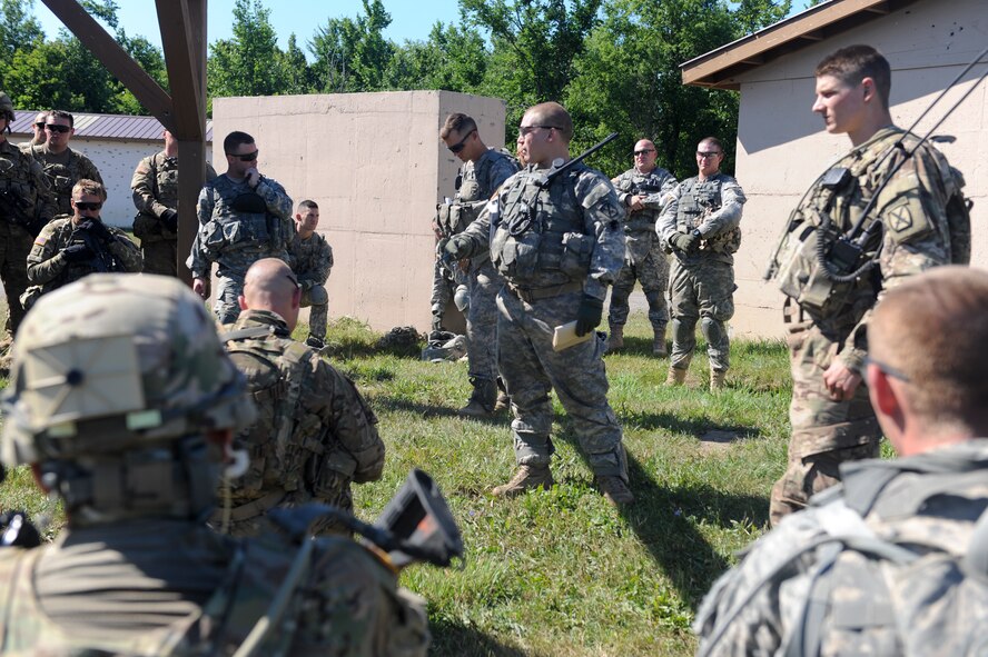 U.S. Army 1st Lt. Karl Skidmore, 3rd Brigade Combat Team, 1-32 Infantry Battalion, executive officer, talks with a platoon after completing a training scenario at Fort Drum, N.Y., July 25, 2012. Skidmore gave feedback on how the platoon could improve their movement in future scenarios. (U.S. Air Force photo by Airman 1st Class Douglas Ellis/Released)
