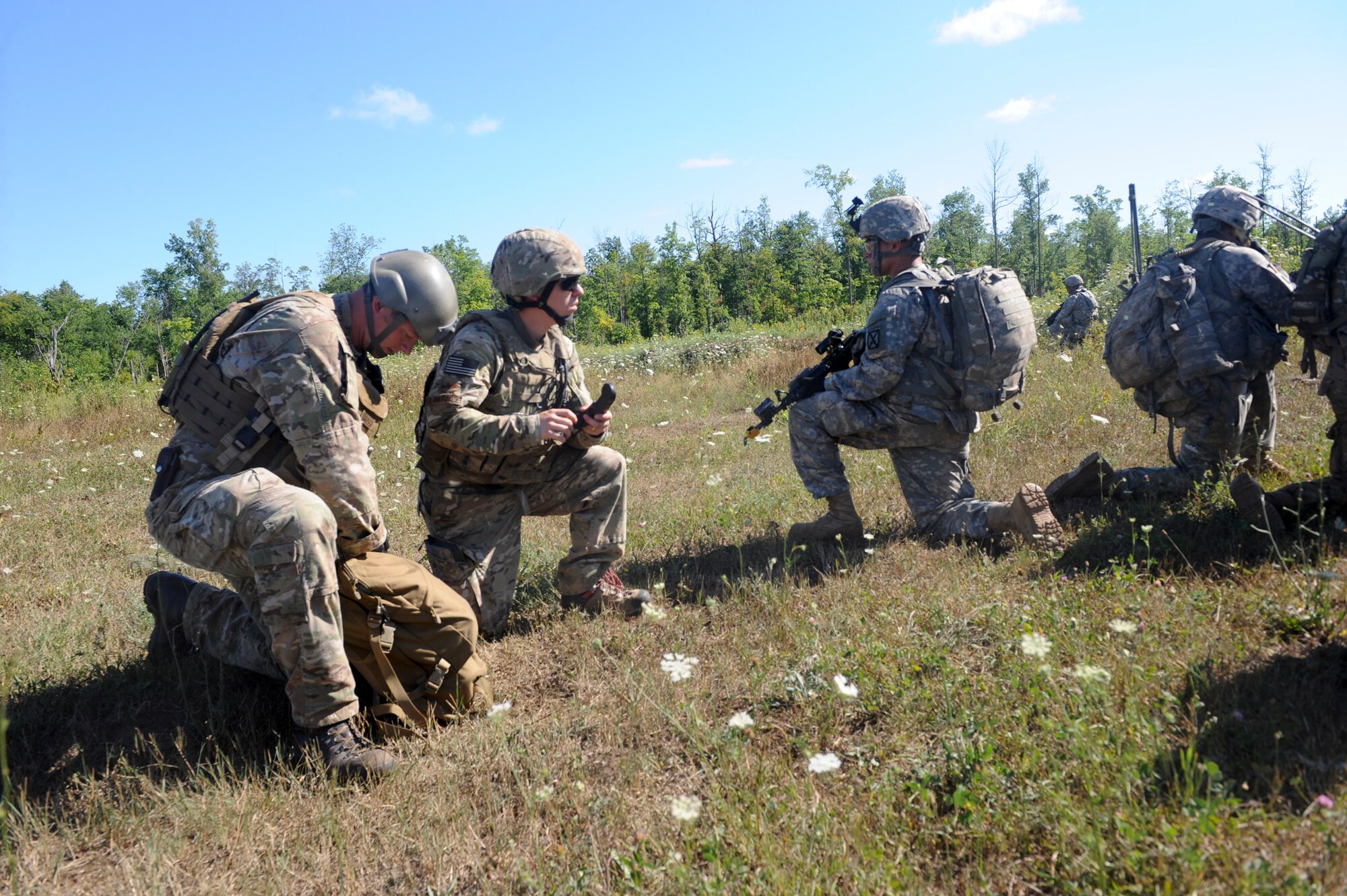 U.S. Air Force Senior Airman Yorke Goddard, 20th Air Support Operations Squadron joint terminal attack controller, and Airman 1st Class Titus Baker, 20th ASOS radio operator, maintenance and driver, work with U.S. Army Soldiers during exercise Mountain Peak at Fort Drum, N.Y., July 25, 2012.  This exercise is held annually and prepared more than 10,000 service members for future deployments.  (U.S. Air Force photo by Airman 1st Class Douglas Ellis/Released)
