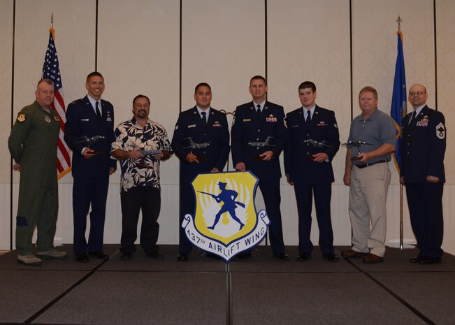 Col. Erik Hansen, 437th Airlift Wing commander (left), and Chief Master Sgt. Gerard Komen, 437th Maintenance Operations Squadron (right), congratulate the 437th Airlift Wing Second Quarter Award Winners after a ceremony at the Charleston Club at Joint Base Charleston – Air Base, Aug. 2, 2012 at JB Charleston, S.C. (left to right) Capt. Justin Berry, 16th Airlift Squadron Junior Company Grade Officer of the Quarter; Mr. Dennis Ingold, 437th Aerial Port Squadron, Civilian Category I of the Quarter; Senior Airman Kenneth Harris, 437th Aircraft Maintenance Squadron, Airman of the Quarter; Master Sergeant John Lipsey, 437th AMXS Senior Noncommissioned Officer in Charge of the Quarter; Senior Airman Daniel Godfrey, 437th APS, Volunteer of the Quarter; Andrew Branch, 437th APS, Civilian Category II of the Quarter. Not pictured are Tech. Sgt. Brian Higgins, 437th Operations Support Squadron, Noncommissioned Officer of the Quarter and Capt. Clark Grosvenor, 16th AS, Company Grade Officer of the Quarter. The winners were nominated by their supervisors for superior performance and hard work. (U.S. Air Force photo by Staff Sgt. Katie Gieratz)
