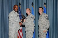 Gen. Alfred J. Stewart, Air Force Personnel Center commander, and Chief Master Sgt. Ruben Gonzales, AFPC command chief, present the NCO of the Quarter Award to Tech. Sgt. Jennifer Brewer, Air Force Personnel Center. The second-quarter Joint Base San Antonio-Randolph award winners were recognized during a ceremony at the base theater August 3.
(U.S. Air Force photo by Melissa Peterson)
