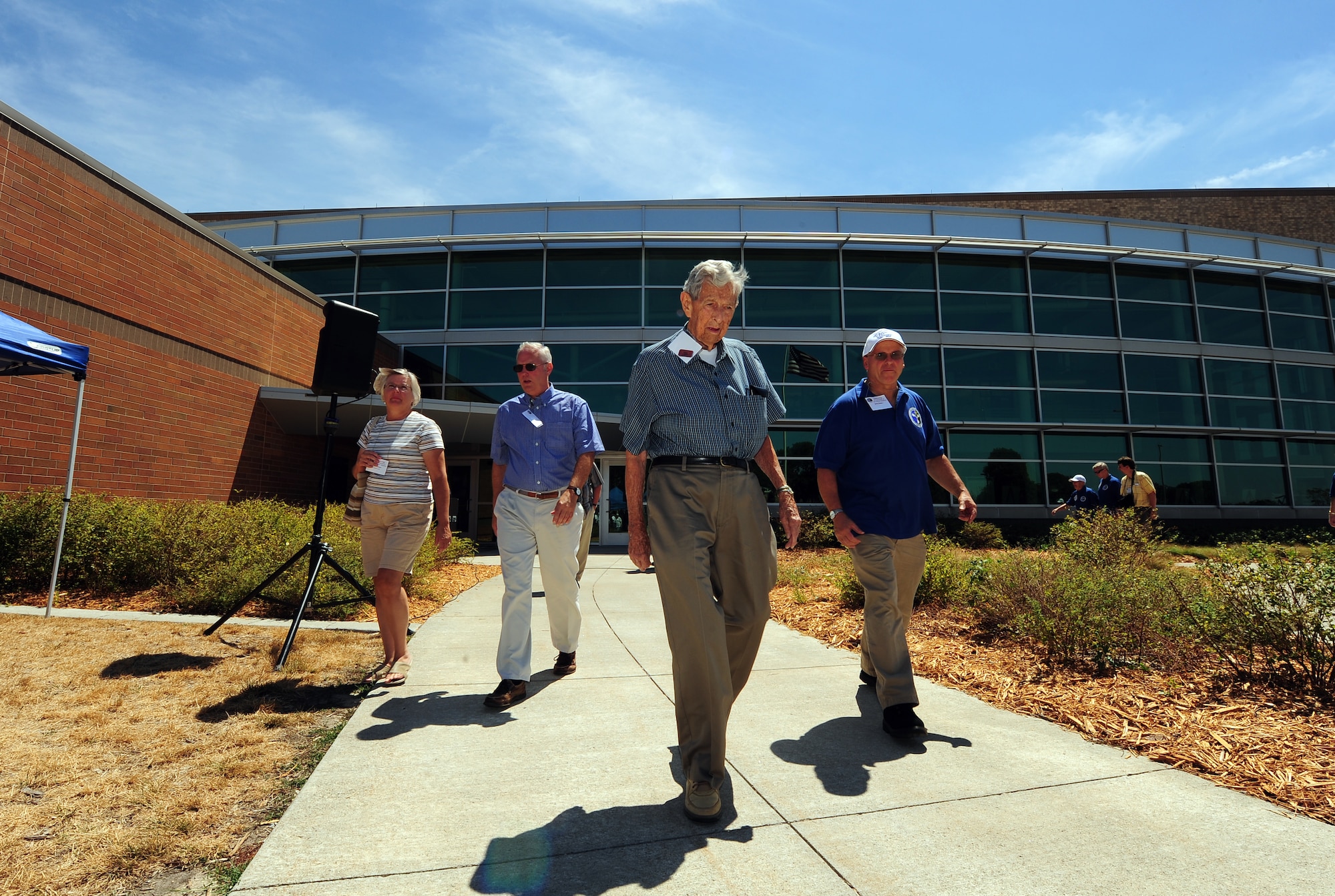 Airman past and present walk around the Air Force Weather Agency headquarters as they find their seats for the 75th Anniversary Air Force Weather celebration and plaque unveiling held at Offutt Air Force Base, Neb., Aug.  2.  Weathers professional from World War II to present active duty were in attendance for the historical anniversary.  (U.S. Air Force Photo by Josh Plueger/Released)