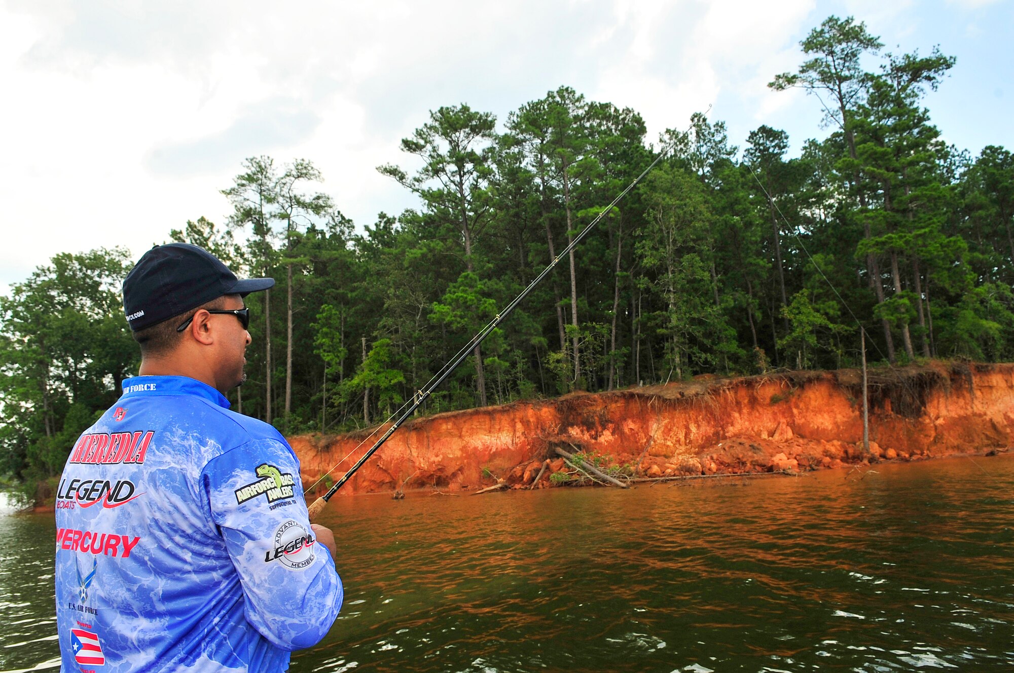 Ray Heredia, U.S. Air Forces Central and 9th Air Force video teleconference engineer, fishes from his Legend Air Force speed boat, Wateree Lake, S.C., Aug. 3, 2012.  Heredia has been competing in bass fishing tournaments since 1994.  He uses the boat for bass fishing tournaments, guided fishing tours and Air Force recruiting.(U.S. Air Force photo by Airman Nicole Sikorski/Released) 