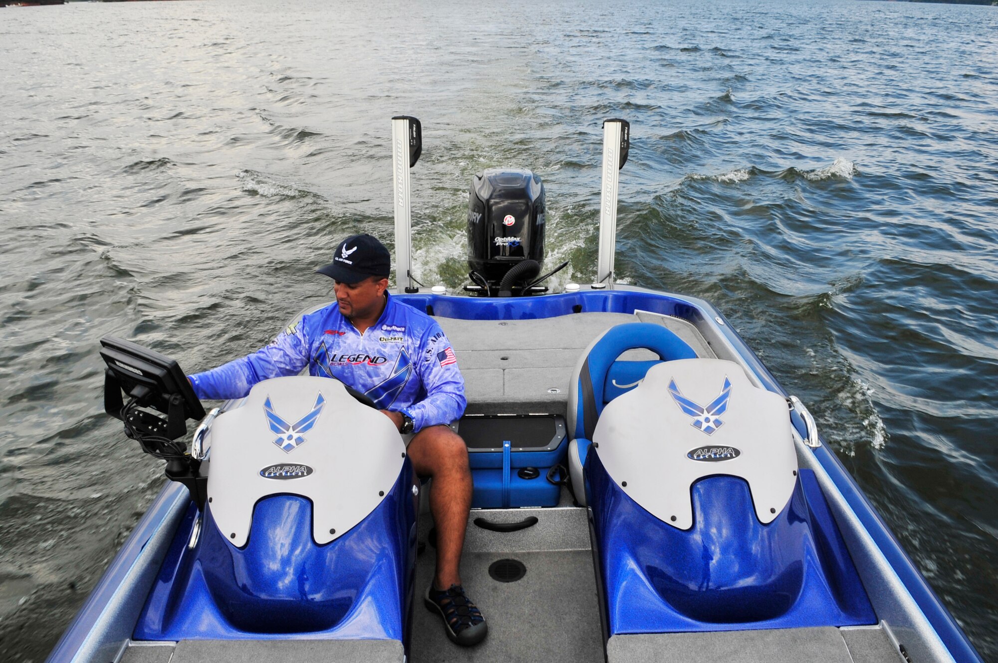 Ray Heredia, U.S. Air Forces Central and 9th Air Force video teleconference engineer, studies his fish finder on his Legend Air Force speed boat, Wateree Lake, S.C., Aug. 3, 2012.  Heredia has been competing in bass fishing tournaments since 1994.(U.S. Air Force photo by Airman Nicole Sikorski/Released) 