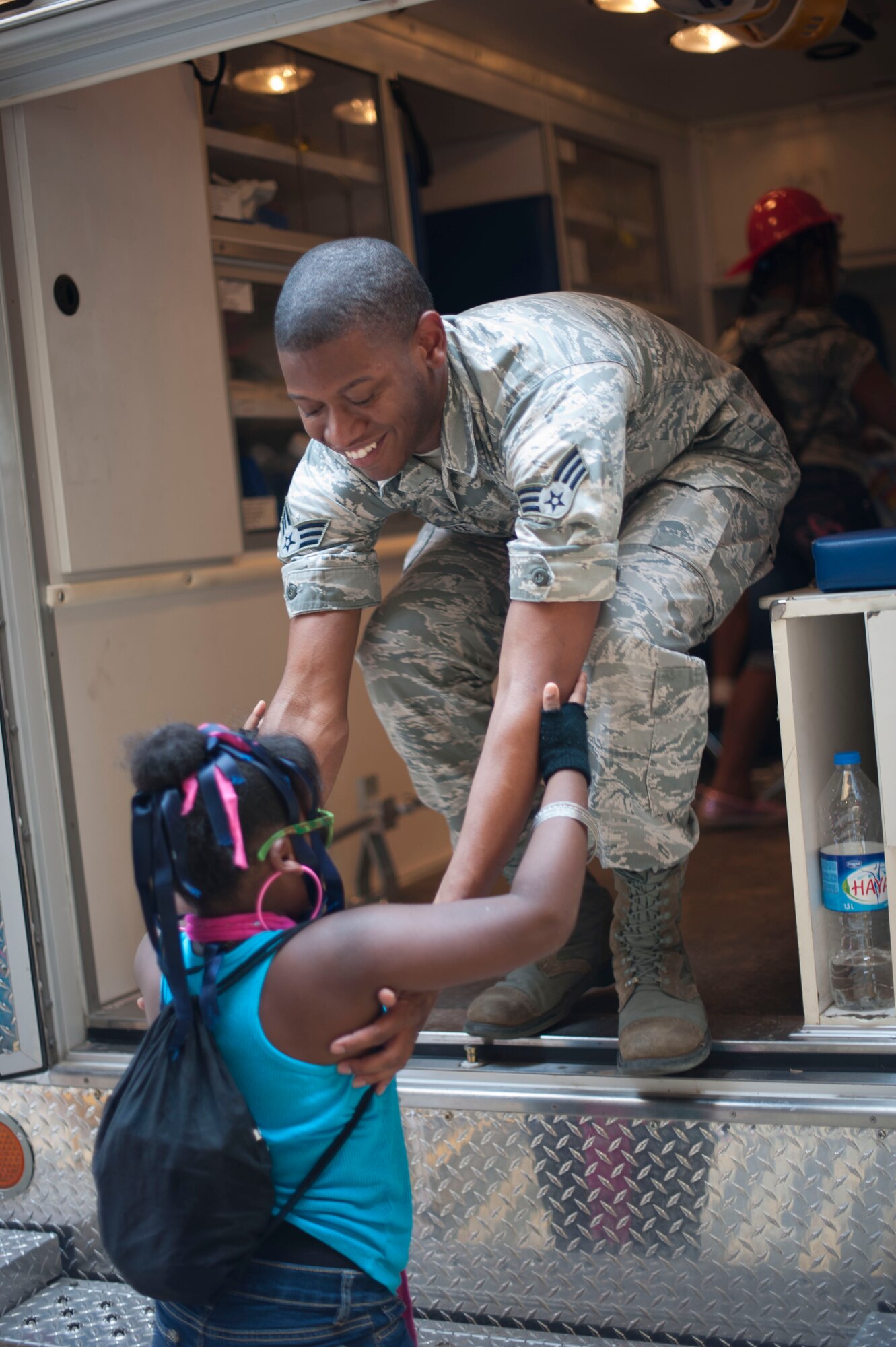 Senior Airman DeSean Burnette, 39th Medical Operations Squadron, lifts a child into an ambulance during Operation Deployment Aug. 3, 2012, at Incirlik Air Base, Turkey. The event gave children and spouses of service members the opportunity to learn about the deployment process. Almost 200 people participated in the event. (U.S. Air Force photo by Senior Airman Clayton Lenhardt/Released)