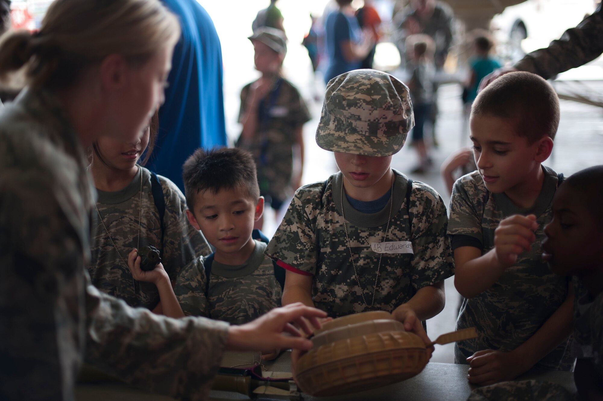 Senior Airman Kristina Stubbs, 39th Civil Engineer Squadron Explosive Ordnance Disposal flight, displays a landmine to Operation Deployment participants Aug. 3, 2012, at Incirlik Air Base, Turkey.  The event gave children and spouses of service members the opportunity to learn about the deployment process. Almost 200 people participated in the event. (U.S. Air Force photo by Senior Airman Clayton Lenhardt/Released)