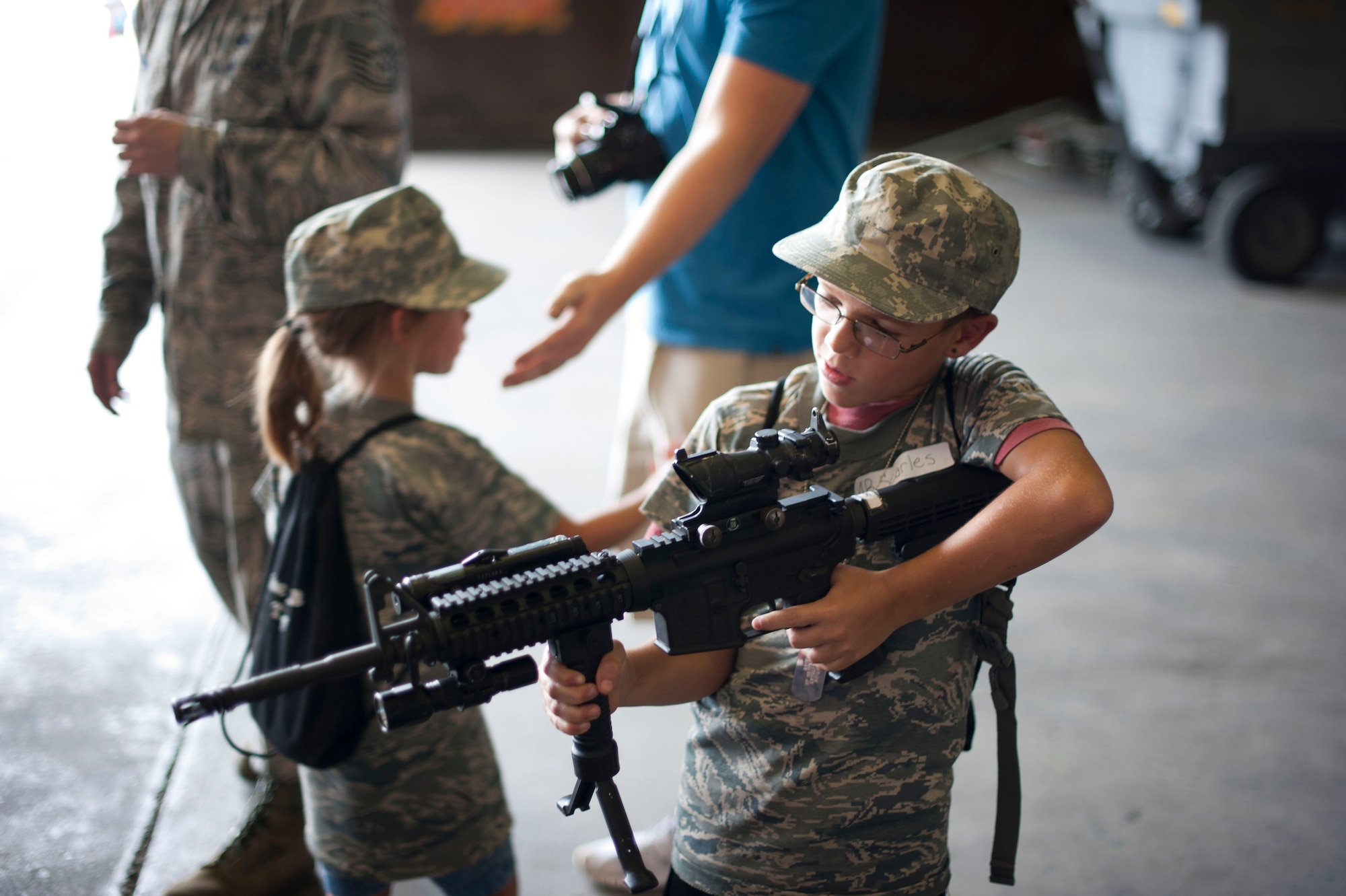 A child examines a weapon during Operation Deployment Aug. 3, 2012, at Incirlik Air Base, Turkey. The event gave children and spouses of service members the opportunity to learn about the deployment process. Almost 200 people participated in the event. (U.S. Air Force photo by Senior Airman Clayton Lenhardt/Released)