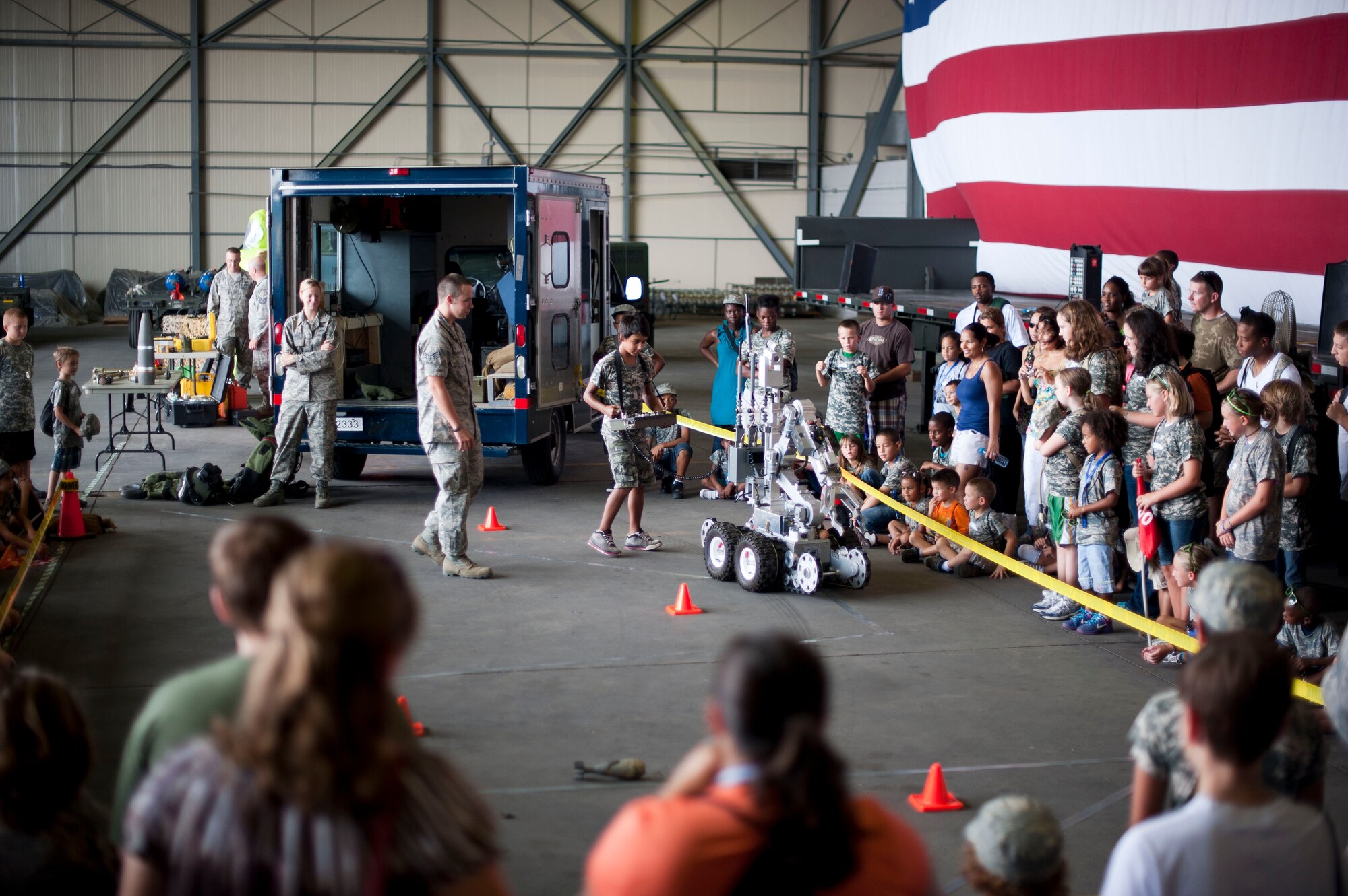 Operation Deployment participants watch a demonstration by the 39th Civil Engineer Squadron Explosive Ordnance Disposal flight Aug. 3, 2012, at Incirlik Air Base, Turkey. The event gave children and spouses of service members the opportunity to learn about the deployment process. Almost 200 people participated in the event. (U.S. Air Force photo by Senior Airman Clayton Lenhardt/Released)
