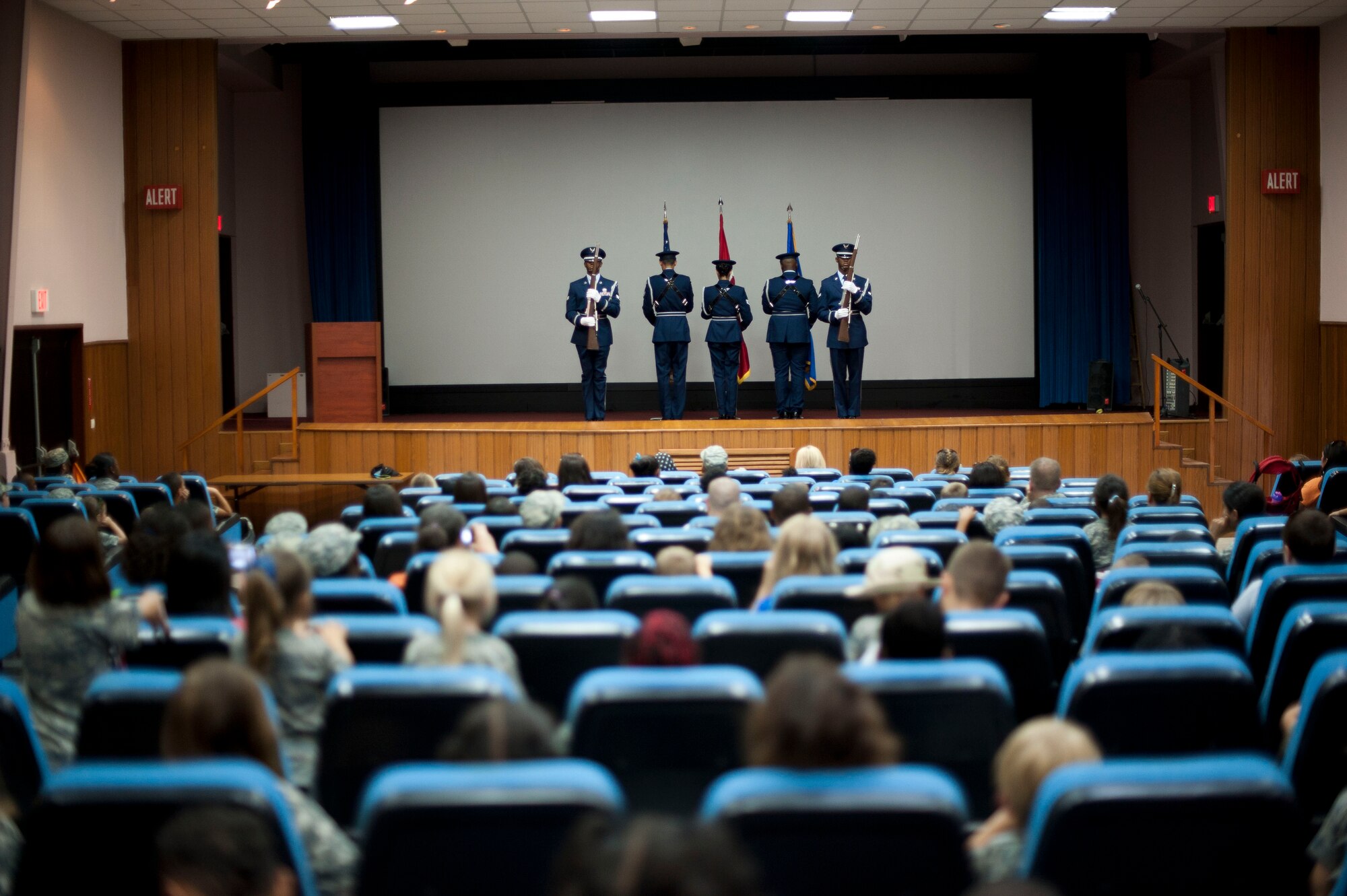 Operation Deployment participants watch a base honor guard demonstration Aug. 3, 2012, at Incirlik Air Base, Turkey. The event gave children and spouses of service members the opportunity to learn about the deployment process. Almost 200 people participated in the event. (U.S. Air Force photo by Senior Airman Clayton Lenhardt/Released)