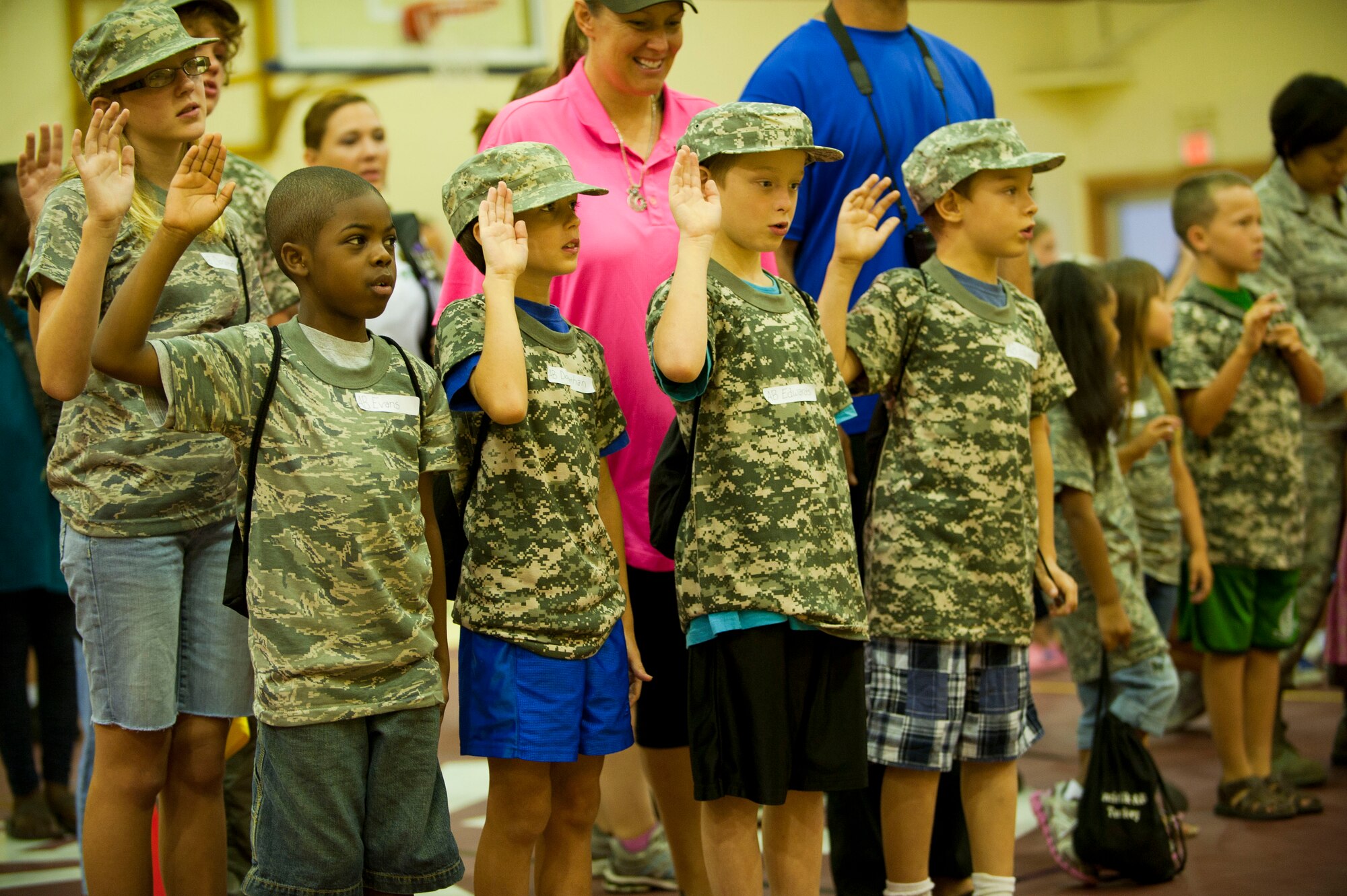 Operation Deployment participants recite the Oath of Enlistment Aug. 3, 2012, at Incirlik Air Base, Turkey. The event gave children and spouses of service members the opportunity to learn about the deployment process. Almost 200 people participated in the event. (U.S. Air Force photo by Senior Airman Clayton Lenhardt/Released)
