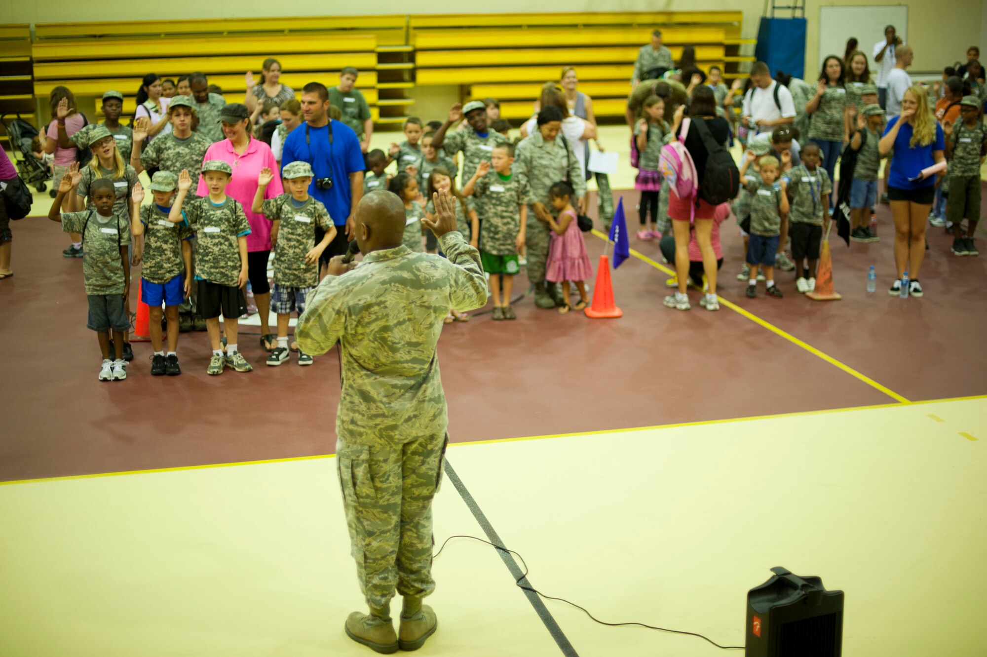 Lt. Col. Lawrence Hicks, 39th Mission Support Group deputy commander, leads Operation Deployment participants in the Oath of Enlistment Aug. 3, 2012, at Incirlik Air Base, Turkey. The event gave children and spouses of service members the opportunity to learn about the deployment process. Almost 200 people participated in the event. (U.S. Air Force photo by Senior Airman Clayton Lenhardt/Released)