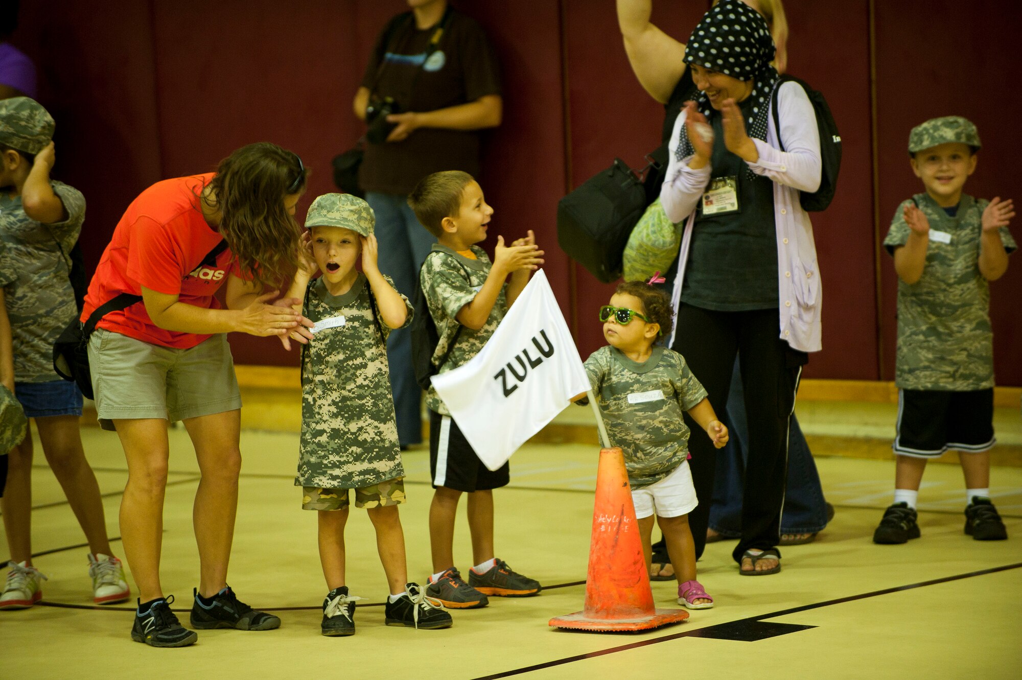 Operation Deployment participants gather by flight in the fitness center basketball court Aug. 3, 2012 at Incirlik Air Base, Turkey. The event gave children and spouses of service members the opportunity to learn about the deployment process. Almost 200 people participated in the event. (U.S. Air Force photo by Senior Airman Clayton Lenhardt/Released)