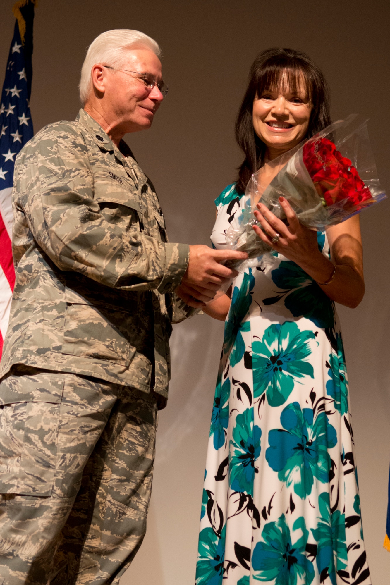 U.S. Air Force Lt. Col. Allen Smith presents a bouquet of roses to his wife Loretta during his retirement ceremony on Barksdale Air Force Base, La., Aug. 5, 2012. Smith is assigned to the 307th Medical Squadron and retired after serving 35 years in the military. (U.S. Air Force photo by Master Sgt. Greg Steele/Released)