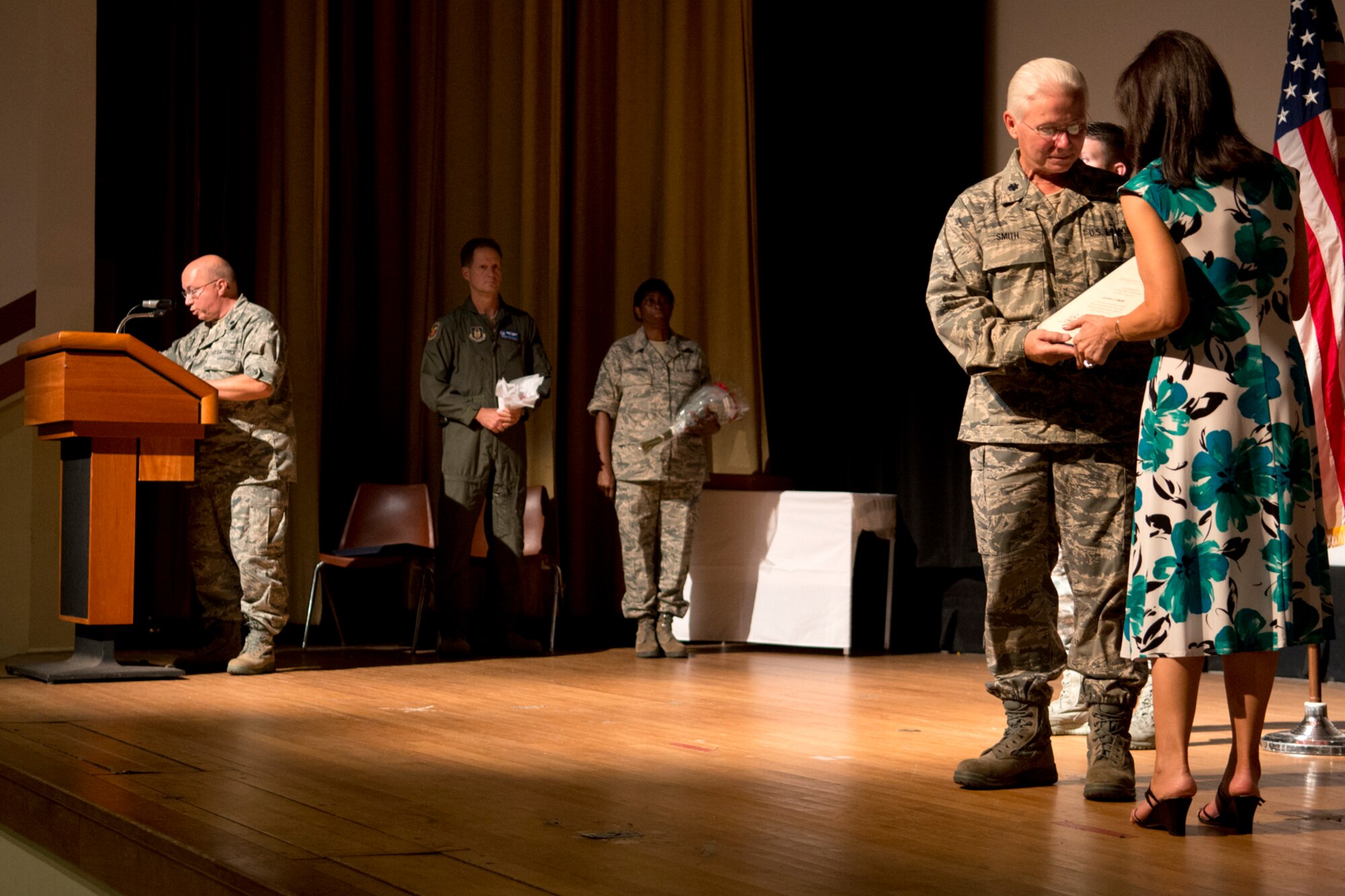 U.S. Air Force Lt. Col. Gary Avallone reads the presentation of the spouse certificate as it is presented to Loretta Smith, wife of retiring Lt. Col. Allen Smith, during a ceremony on Aug. 5, 2012, Barksdale Air Force Base, La. Smith is retiring from the Air Force Reserve and was assigned to the 307th Medical Squadron. (U.S. Air Force photo by Master Sgt. Greg Steele/Released)