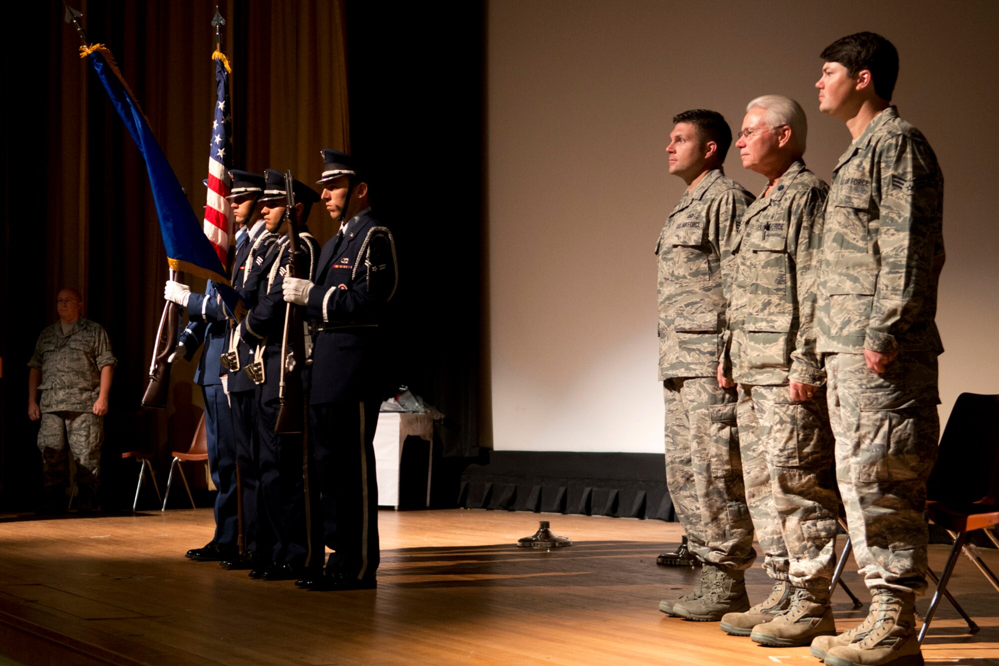 U.S. Air Force Staff Sgt. Patrick Smith, Lt. Col. Allen Smith and Senior Airman Eric Smith, stand at attention during the Posting of the Colors by the Barksdale Air Force Base Honor Guard during a retirement ceremony on Barksdale AFB, La., Aug 5, 2012. Patrick and Eric Smith, sons of Lt .Col. Smith, are both members of the Air Force Reserve, serving at Barksdale and Little Rock Air Force Base, Ark. (U.S. Air Force photo by Master Sgt. Greg Steele/Released)