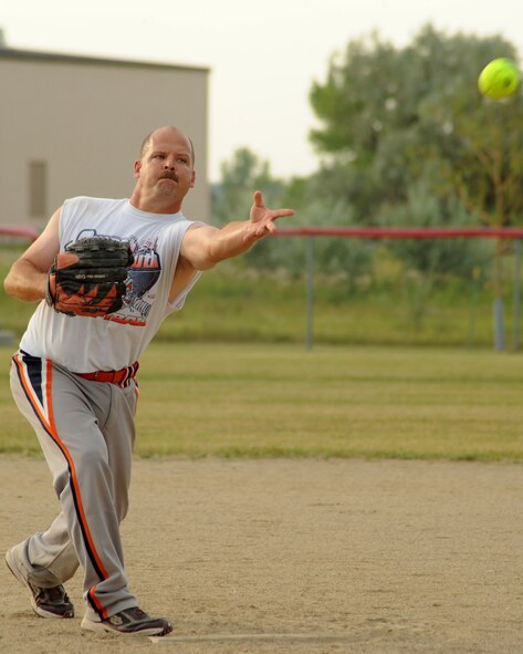 Senior Master Sgt. Steven Pecht, 69th Reconnaissance Group, pitches the ball during the intramural softball championship, Aug. 1, 2012, on Grand Forks Air Force Base, N.D.  The 69th RG defeated the 319th Logistics Readiness Squadron 18-11.  (U.S. Air Force photo by Airman 1st Class Xavier Navarro)