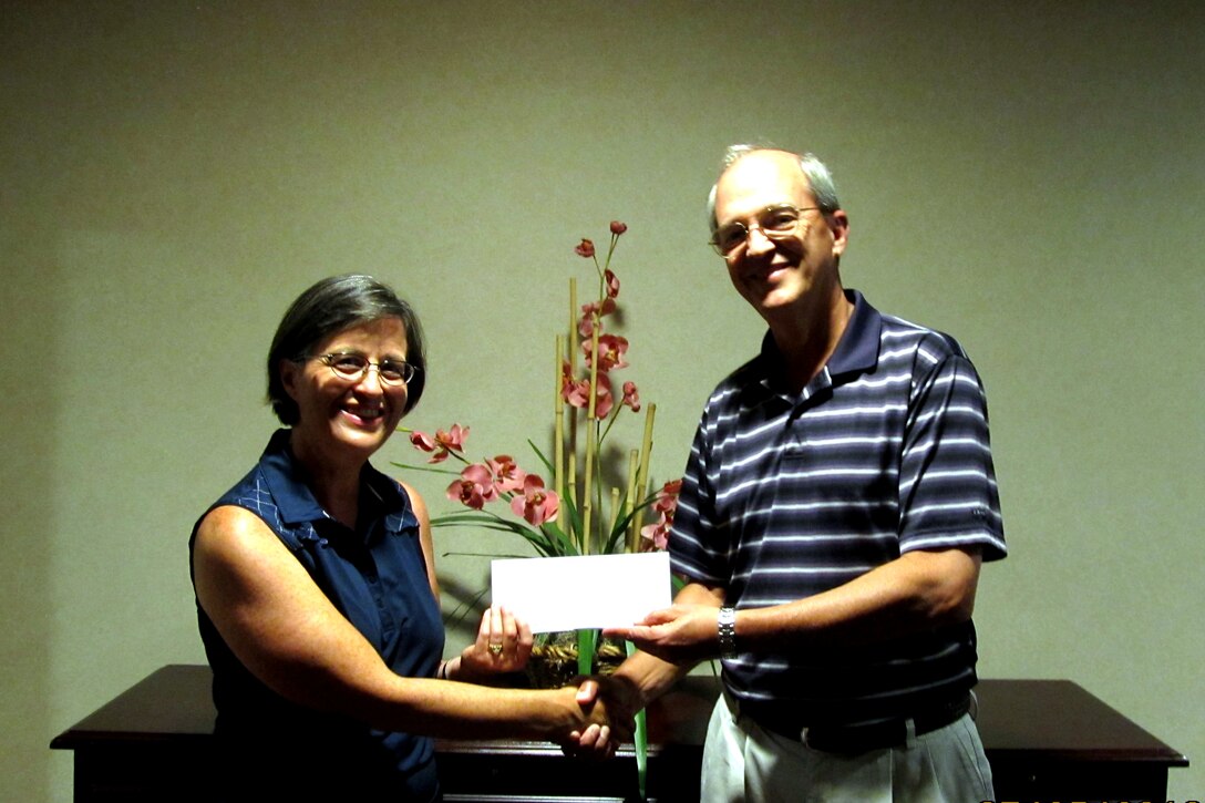 Kay Balzano, Langley Officers' Spouses' Club president, accepts a check for $2,750 from Tim Peppe, Northrop Grumman Corporation Air Force Programs corporate lead executive, for the 2013 scholarship fund.  Northrop Grumman makes annual contributions to the LOSC Scholarship Fund, which awards scholarships to dependents of military personnel assigned to Langley Air Force Base, Va.  In May 2012, the LOSC awarded $7,000 in scholarships to high school seniors and a spouse for their college education. (Courtesy photo by Robin Henley/Released)