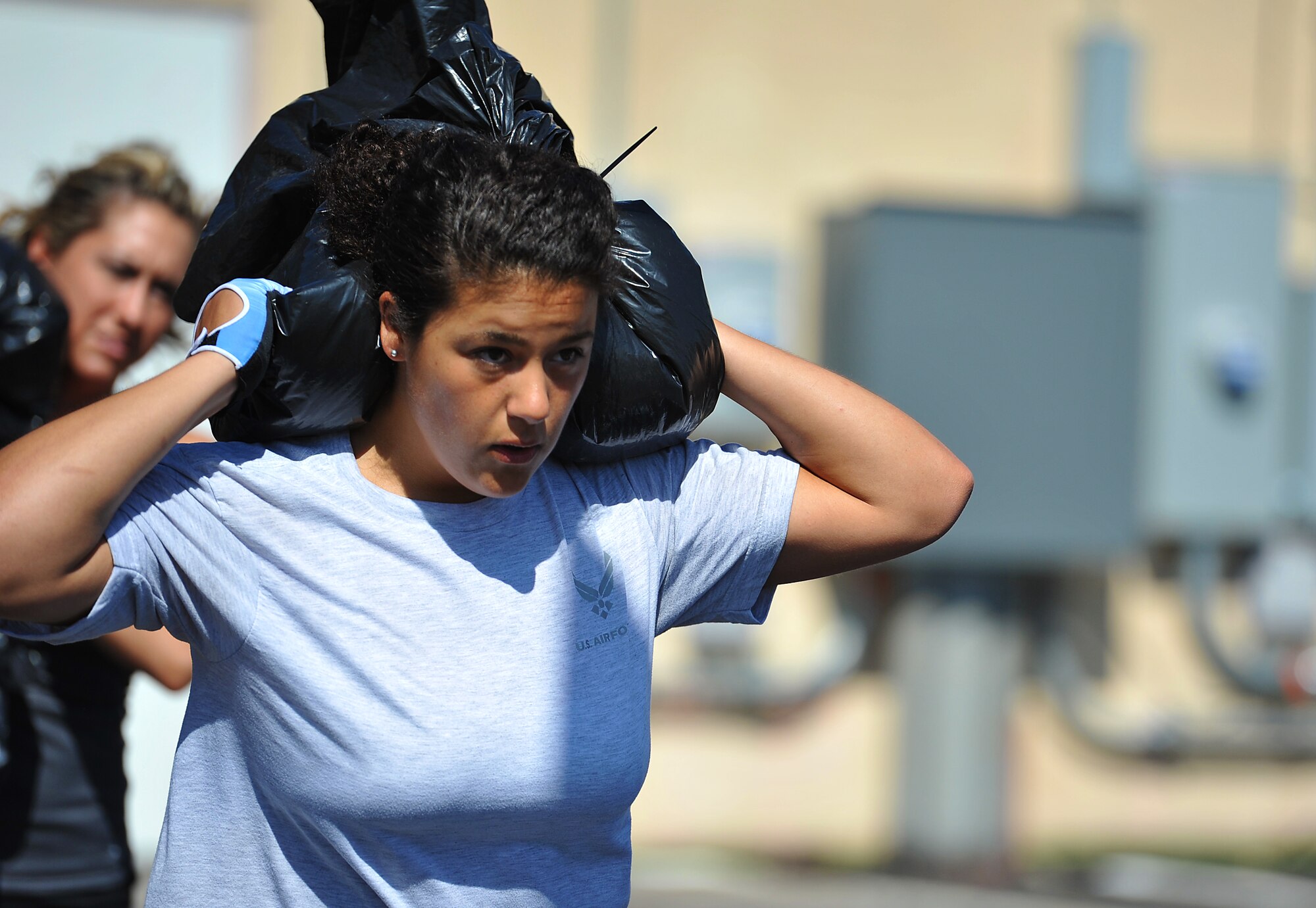 SAN ANGELO, Texas-- Airman 1st Class Aleah Mohamed, 316th Training Squadron student, runs 400 meters while carrying a sandbag during her workout while participating in the 31 Heroes Project at San Angelo CrossFit Aug. 4. San Angelo CrossFit raised close to $2,500 for the 31 Heroes Project, which exists to honor fallen heroes killed in action on Aug. 6, 2011. Raising awareness through fitness, the projects aims to garner funds for programs that provide support to families of all fallen military heroes. (U.S. Air Force photo/Airman 1st Class Michael Smith) 