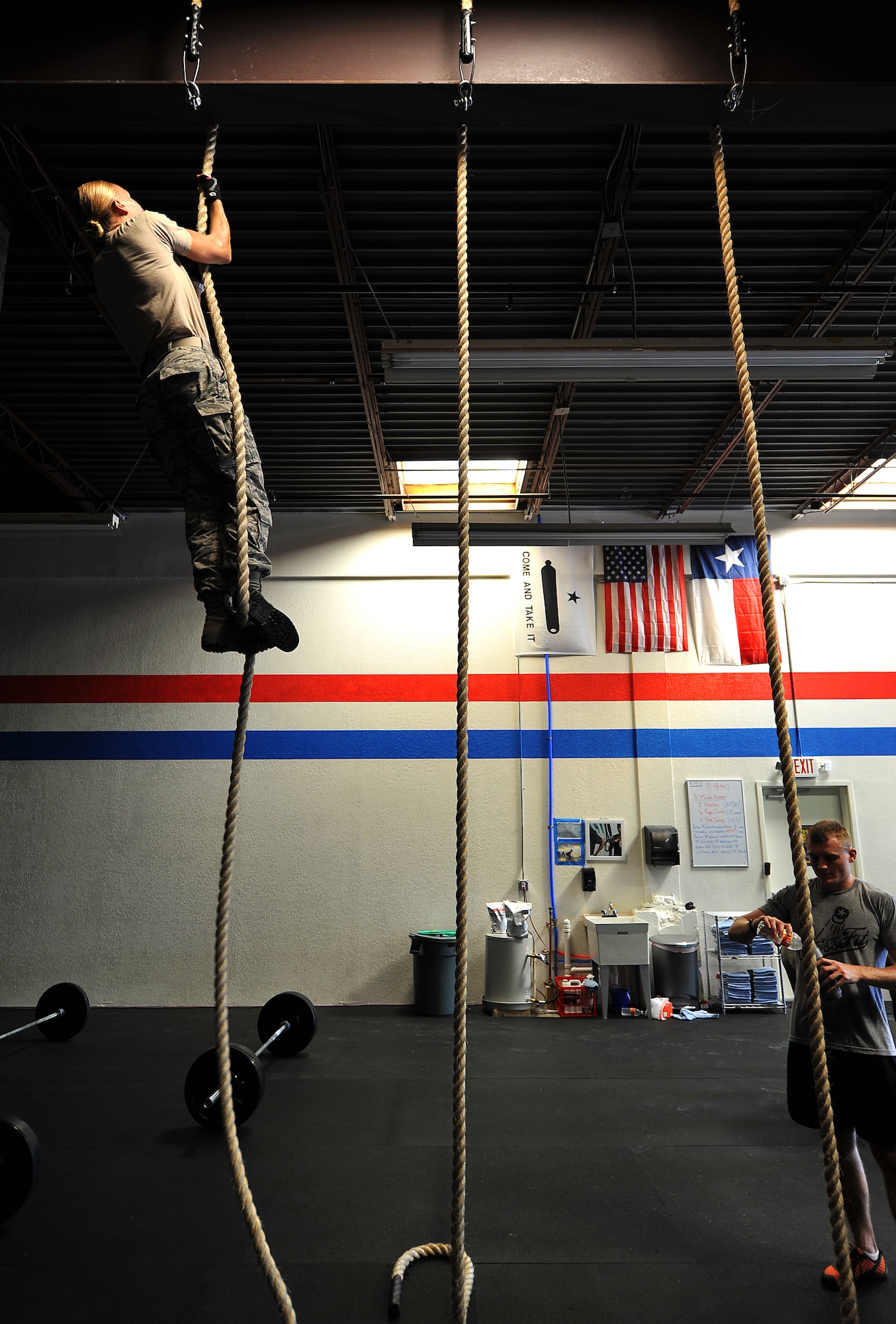 SAN ANGELO, Texas--2nd Lt. Kaylee Martin, 315th Training Squadron, climbs to the top of the rope during her workout while participating in the 31 Heroes Project at San Angelo CrossFit Aug. 4. San Angelo CrossFit raised close to $2,500 for the 31 Heroes Project, which exist to honor fallen heroes killed in action on August 6, 2011. Raising awareness through fitness, the projects aims to garner funds for programs that provide support to families of all fallen military heroes. (U.S. Air Force photo/Airman 1st Class Michael Smith)