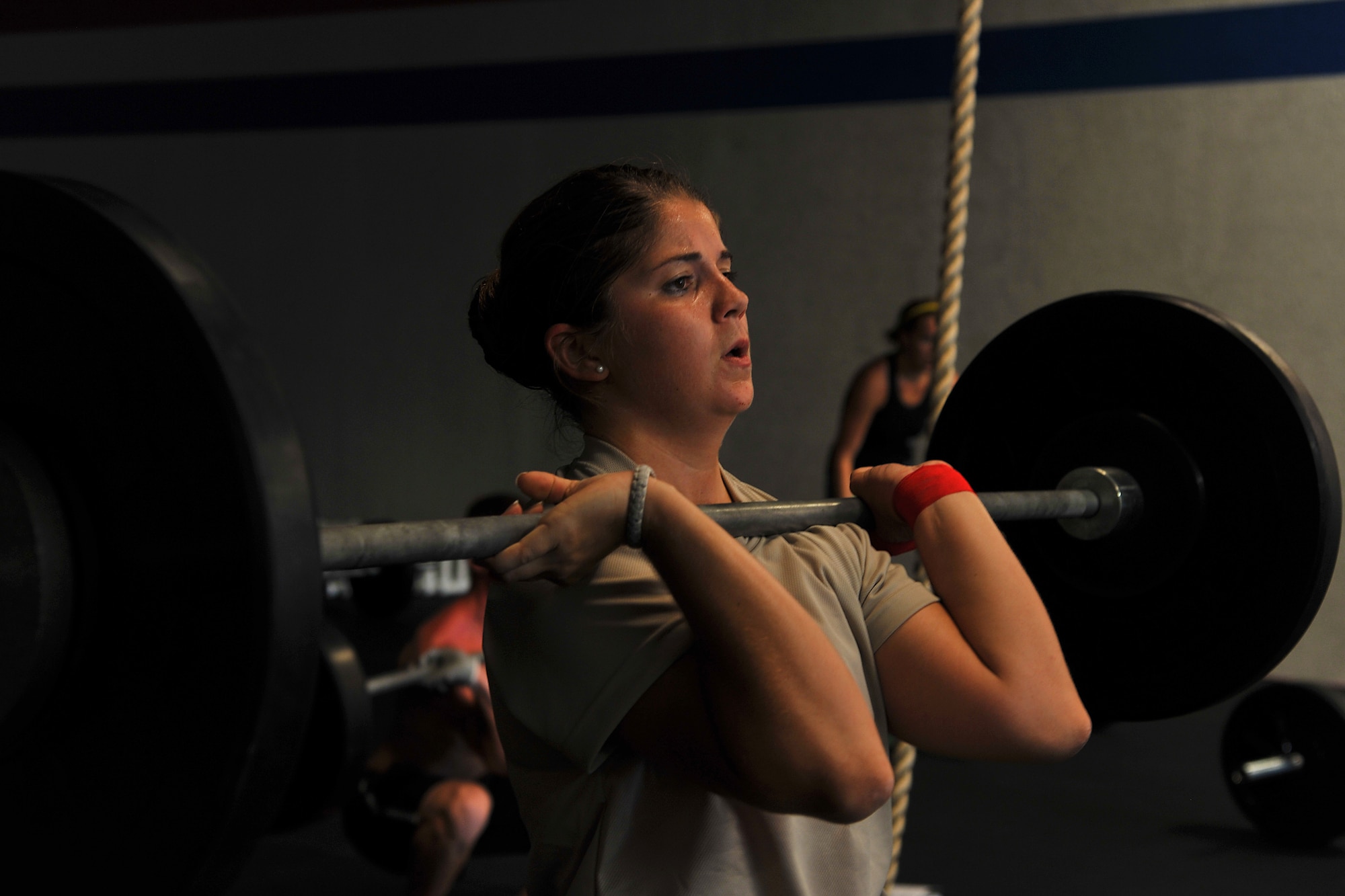 SAN ANGELO, Texas-- 2nd Lt. Sarah Page, 315th Training Squadron student, lifts weights during her workout while participating in the 31 Heroes Project at San Angelo CrossFit Aug. 4. San Angelo CrossFit raised close to $2,500 for the 31 Heroes Project, which exist to honor fallen heroes killed in action on August 6, 2011. Raising awareness through fitness, the projects aims to garner funds for programs that provide support to families of all fallen military heroes. (U.S. Air Force photo/Airman 1st Class Michael Smith)