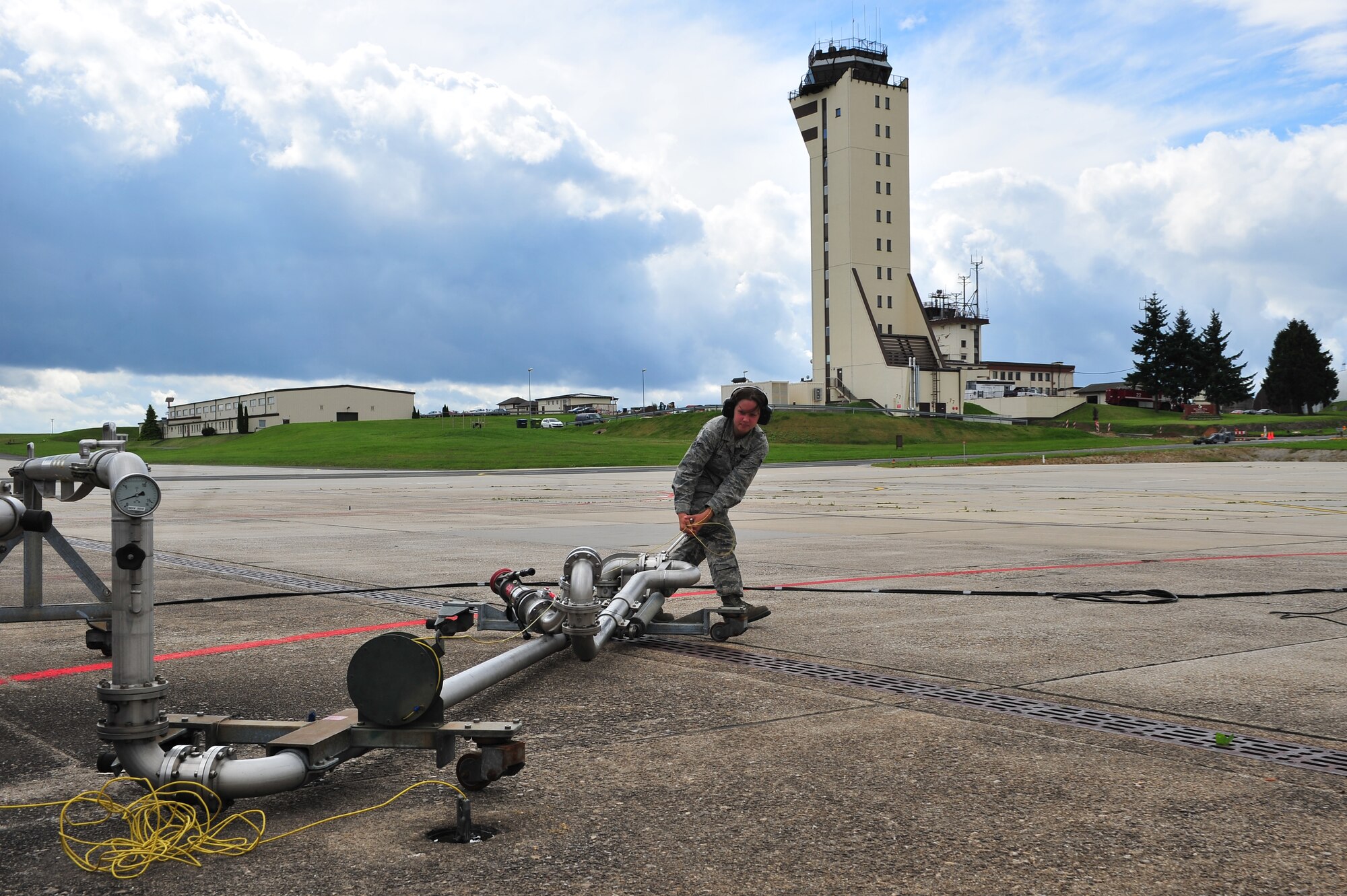 SPANGDAHLEM AIR BASE, Germany – Airman 1st Class Heather Dixon, 52nd Logistics Readiness Squadron fuels distribution operator, drags an aircraft fuel pump out to an A-10 Thunderbolt II during a hot pit refueling on Ramp 3 here Aug. 6. A hot pit is the refueling of a jet while the aircraft is still running so pilots can take off right away. The fuels distribution shop quality tests aircraft fuel, conducts hot pit operations and takes accountability for all aircraft fuel. (U.S. Air Force photo by Airman 1st Class Dillon Davis/Released)