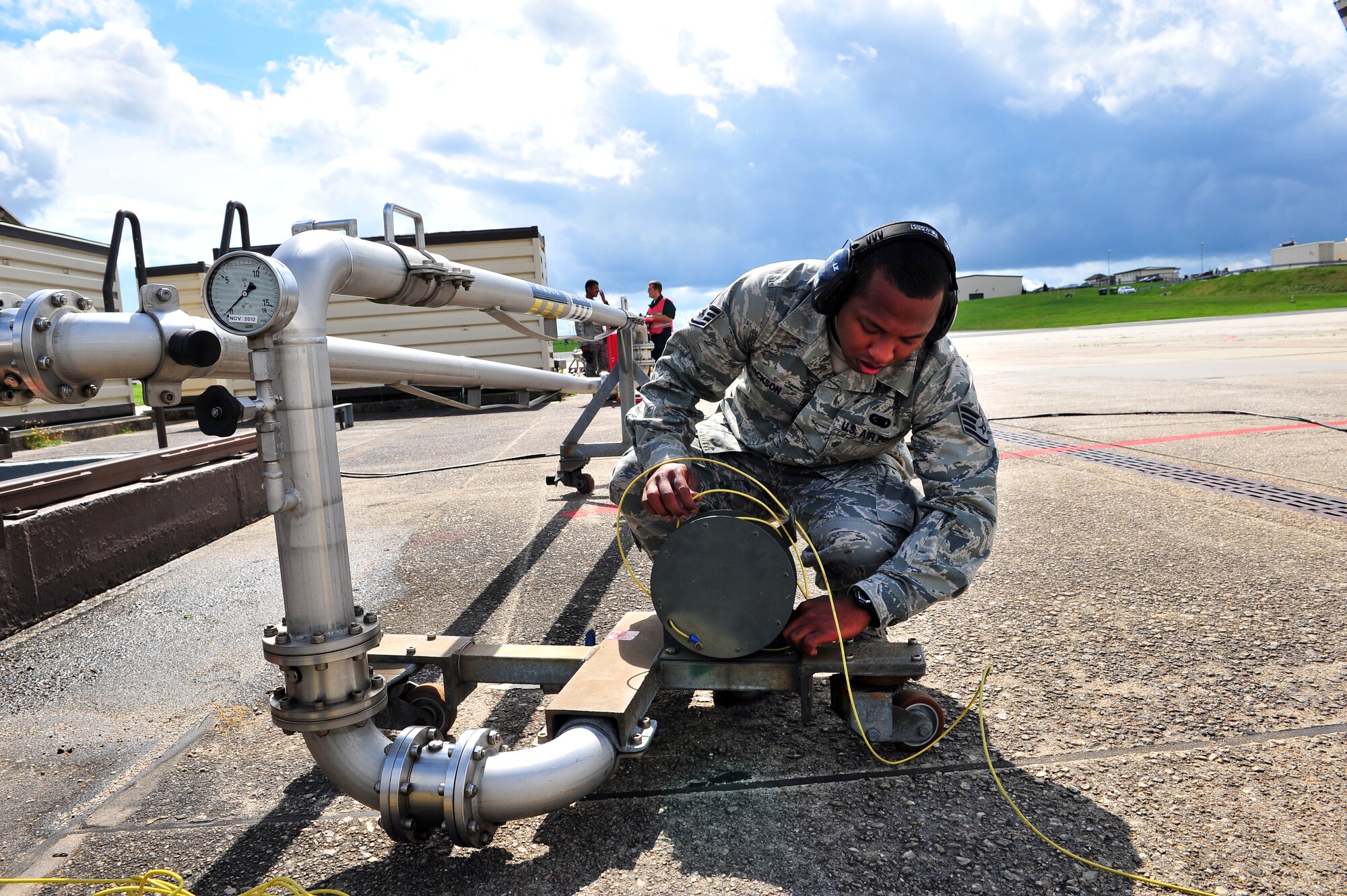 SPANGDAHLEM AIR BASE, Germany – Staff Sgt. Matthew Jackson,  52nd Logistics Readiness Squadron fuels distribution supervisor, unravels a grounding cable before it can be connected to an A-10 Thunderbolt II during a hot pit refueling on Ramp 3 here Aug. 6. A hot pit is the refueling of a jet while the aircraft is still running so pilots can take off right away. The fuels distribution shop quality tests aircraft fuel, conducts hot pit operations and takes accountability for all aircraft fuel. (U.S. Air Force photo by Airman 1st Class Dillon Davis/Released)