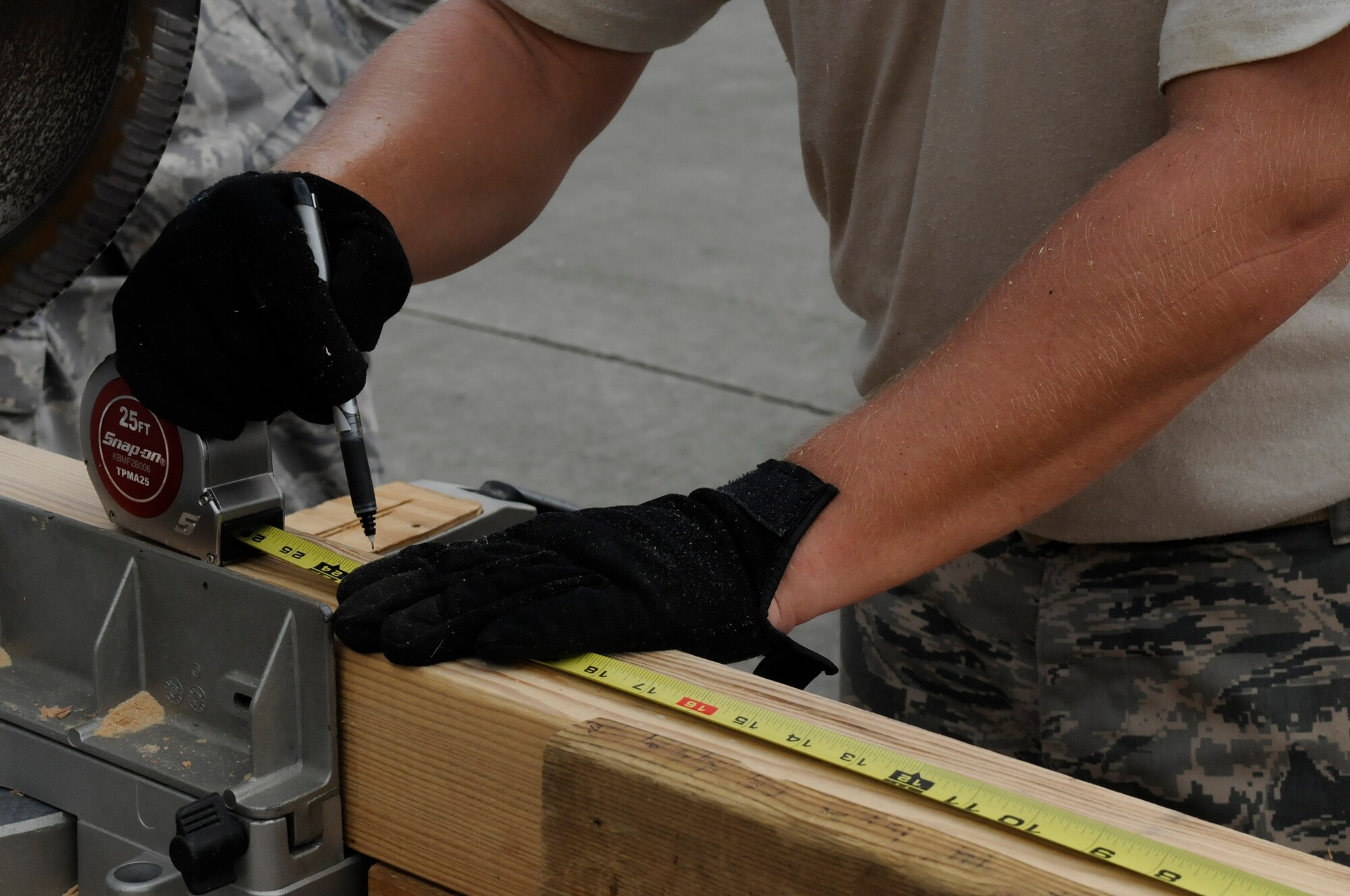Members of the 18th Munitions Squadron Tactical Air Rapid Response Package measure and cut pieces of wood for frames to support pallets of munitions being shipped in cargo containers on Kadena Air Base, Japan, July 31, 2012. Roughly 270 containers will be shipped during the 18th MUNS latest operation to support the Pacific Air Forces' mission. (U.S. Air Force photo/Airman Tara A. Williamson)