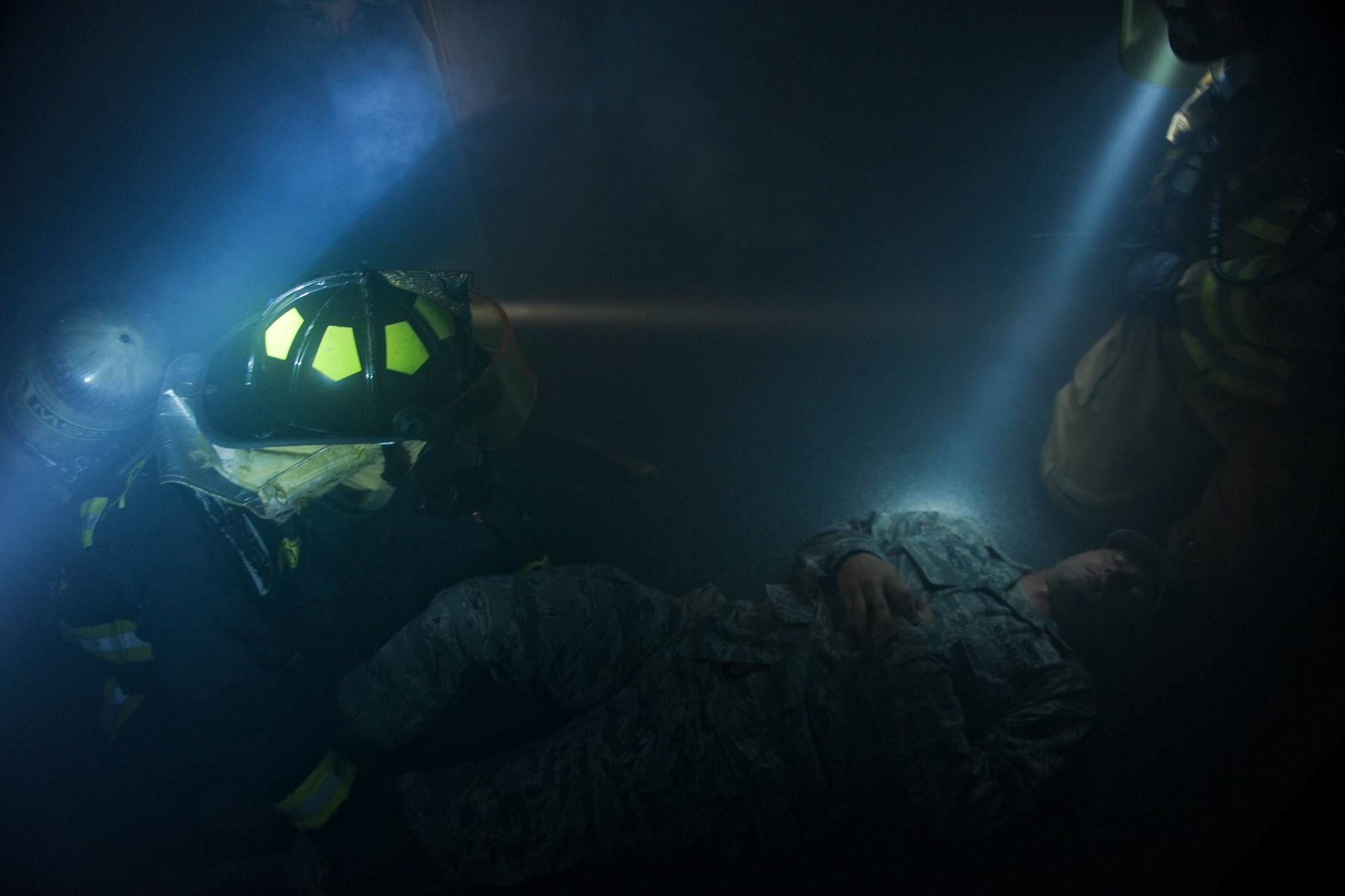 Firefighters respond to simulated victim U.S. Air Force Staff Sgt. Brennen Cornett, 18th Civil Engineer Squadron firefighter, during a training scenario on Kadena Air Base, Japan, Aug. 2, 2012. This was a structural fire exercise where two victims were trapped inside from a kitchen fire. (U.S. Air Force photo/Airman 1st Class Justin Veazie)