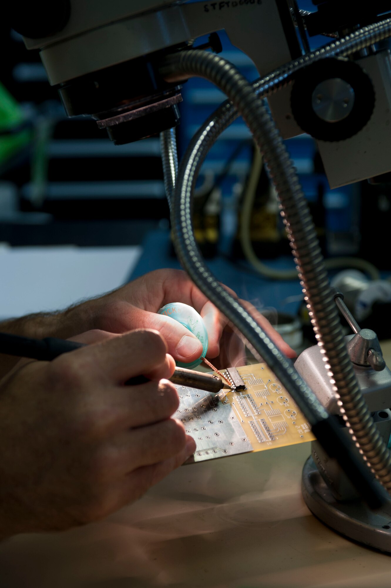 SPANGDAHLEM AIR BASE, Germany – Master Sgt. Daniel Egbert, 372nd Training Squadron Detachment 17 Miniature and Micro-miniature Repair Program instructor, solders circuit board components Aug. 1 during the 2M program at the 372nd TRS’ Detachment 17 here. The 2M course is a U.S. Navy certification program, which teaches Airmen how to do in-house repairs on circuit board components that would otherwise be sent back to the manufacturer or to heavy maintenance for repair or thrown away. Last year, the program saved U.S. Air Forces in Europe $4.8 million. (U.S. Air Force photo by Senior Airman Natasha Stannard/Released)