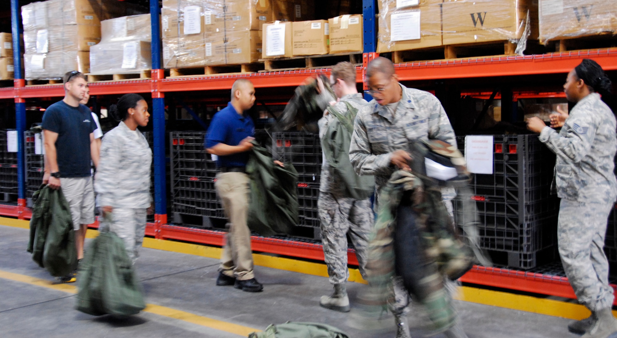 YOKTOA AIR BASE, Japan -- Staff Sgt. Angela Holden, 374th Logistics Readiness Squadron Individual Protection Equipment supervisor, right, shows new Yokota Airmen where to find their gear Aug. 7, 2012. The LRS IPE flight manages 26,000 critical supplies and equipment utilized by Yokota Airmen for training and real-world purposes. (U.S. Air Force photo by Senior Airman Lynsie Nichols)