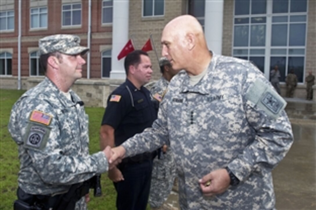 Army Chief of Staff Gen. Ray Odierno presents coins for excellence to soldiers and police officers supporting his visit to the 3rd Infantry Division headquarters on Fort Stewart, Ga., Aug. 6, 2012. Odierno also hosted a re-enlistment ceremony for 30 soldiers. 