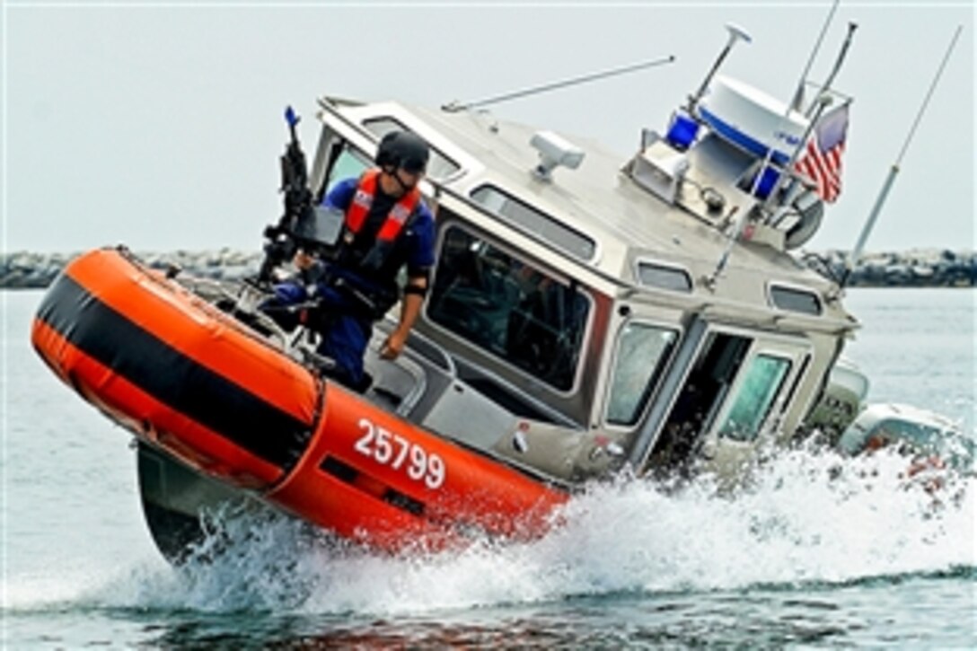 Coast Guard crewmen conduct tactical boat maneuvers during an exercise in San Pedro, Calif., July 31, 2012. The exercise tested the unit's ability to protect a ship docked at a pier as well as under way, using four Coast Guard small boats. The crewman are assigned to the Maritime Safety and Security Team Los Angeles/Long Beach.