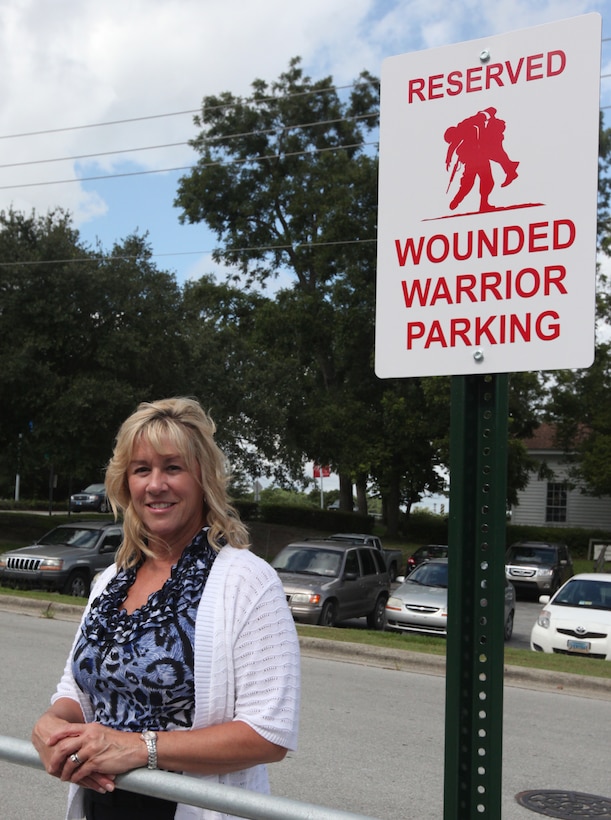 Becky Pollard, the registrar with Onslow County’s Register of Deeds stands by a wounded warrior parking sign at the E.W. Summersill Courts Building in Jacksonville. Pollard and her staff recently contacted county officials to create the wounded warrior and new mother parking spaces which were previously reserved for judges. 