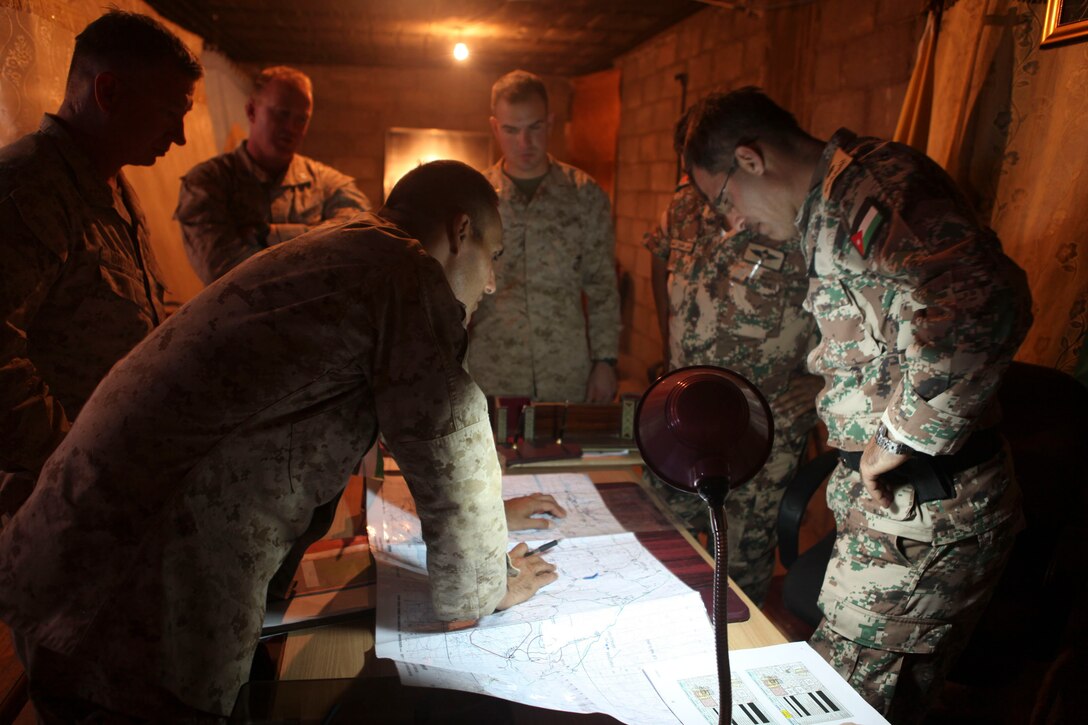 JABAL PETRA, Jordan -   Lieutenant Col. David Sosa, a native of Brooklyn, N.Y., and commanding officer of Battalion Landing Team 1st Battalion, 2nd Marine Regiment, 24th Marine Expeditionary Unit, studies a map of a training area May 5, 2012, with Jordanian Army Lieutenant Col. Saif, commander of the Jordanian 4th Tank Battalion, to prepare for upcoming training opportunities together during Exercise Eager Lion 12. During Eager Lion 12 the 24th MEU will participate in a variety of training exercises with partnered nations at different locations throughout the country to increase interoperability and learn about other countries’ militaries.  Eager Lion 12 is a recurring, multinational exercise designed to strengthen military-to-military relationships through a joint, whole-of-government, multinational approach to future complex national security challenges. The 24th MEU, partnered with the Iwo Jima Amphibious Ready Group, is currently deployed to the Central Command area of operations as a theater reserve and crisis response force capable of a variety of missions from full-scale combat operations to humanitarian assistance and disaster relief.   (Official Marine Corps Photo by Gunnery Sgt. Chad R. Kiehl/RELEASED)