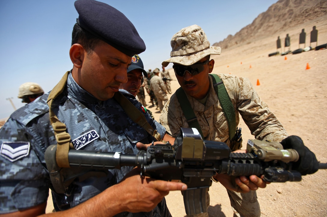 TINTIN, Jordan - Staff Sgt. Jaime Orozco, the radio team operator for the Maritime Raid Force, 24th Marine Expeditionary Unit assists a Marine of the Royal Jordanian Armed Forces with a weapon inspection prior to an advanced combat marksmanship exercise, as part of Eager Lion here, May 13, 2012. Eager Lion is a multinational exercise designed to strengthen military-to-military relationships among partnered nations through scenario-based, realistic modern-day security challenges. The 24th MEU, partnered with the Iwo Jima Amphibious Ready Group, is currently deployed to the U.S. Central Command area of operations as a theater reserve and crisis response force. (Official USMC Photo by: Cpl. Michael J. Petersheim/Released)